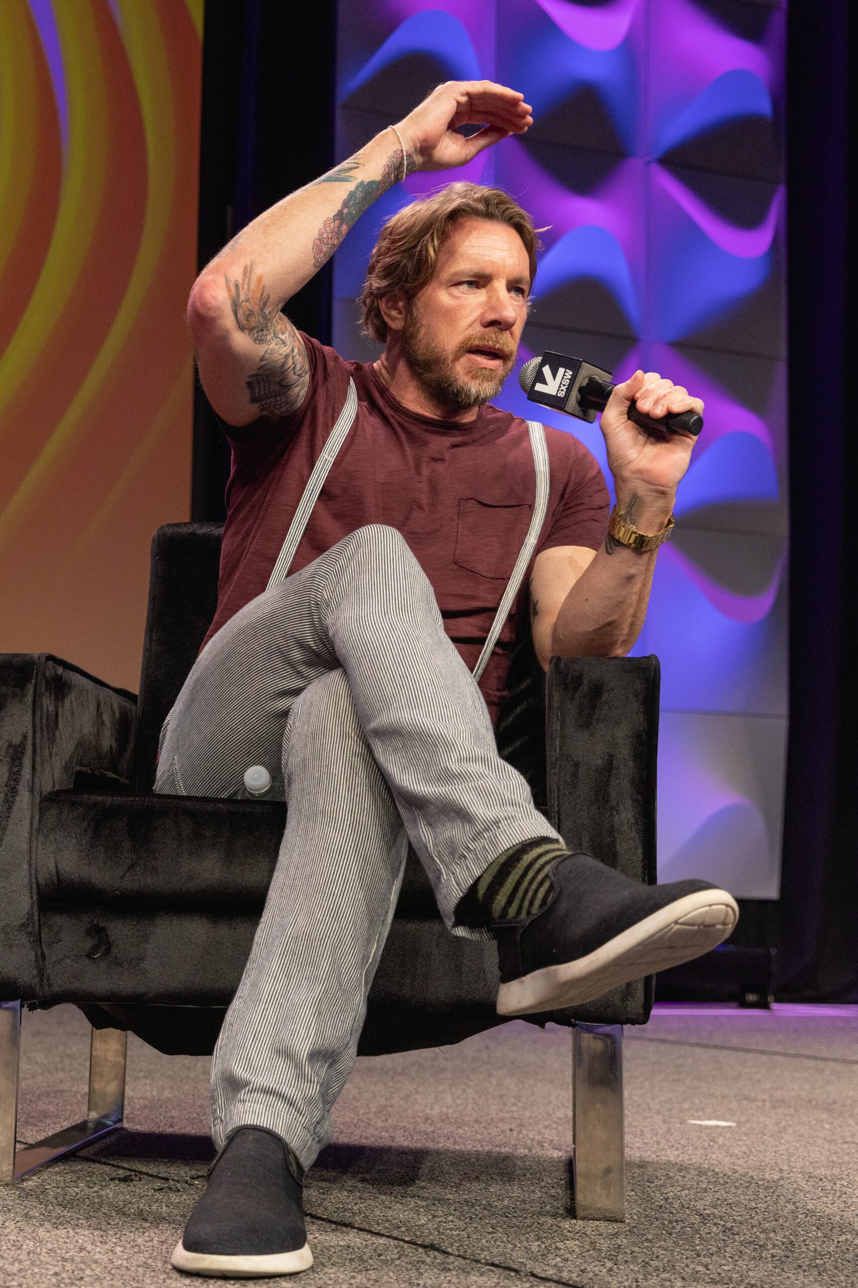 Dax Shepard tattoos: high-resolution portrait with the four solid black stars and additional arm ink visible