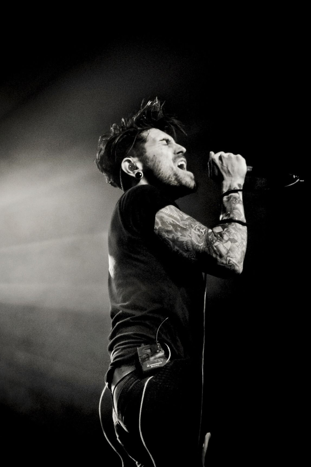 Davey Havok tattoos: high-resolution AFI performance image showing the arm tattoos while Davey sings on stage