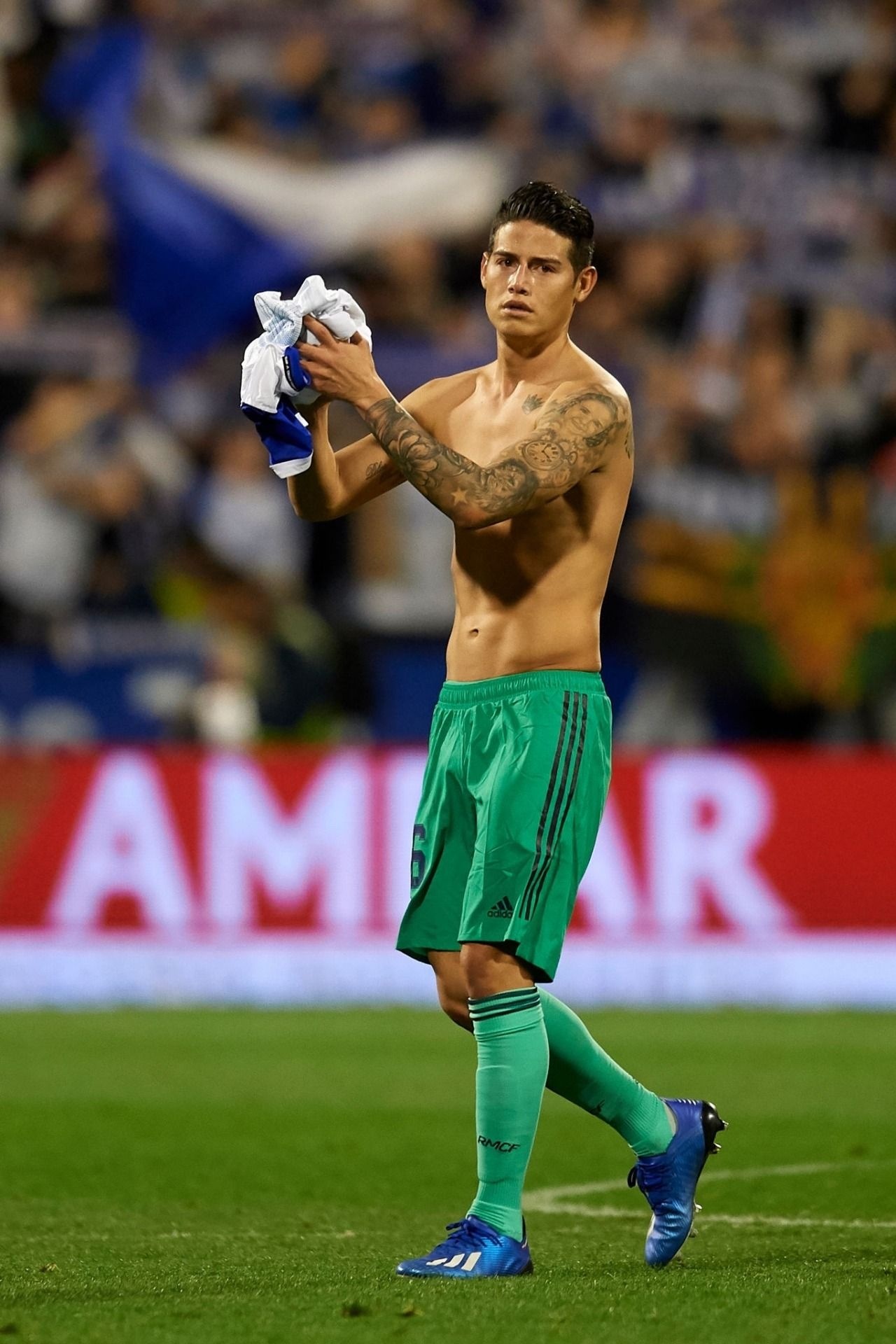 James Rodríguez tattoos: full-height match photo showing the connected black-and-grey arm work
