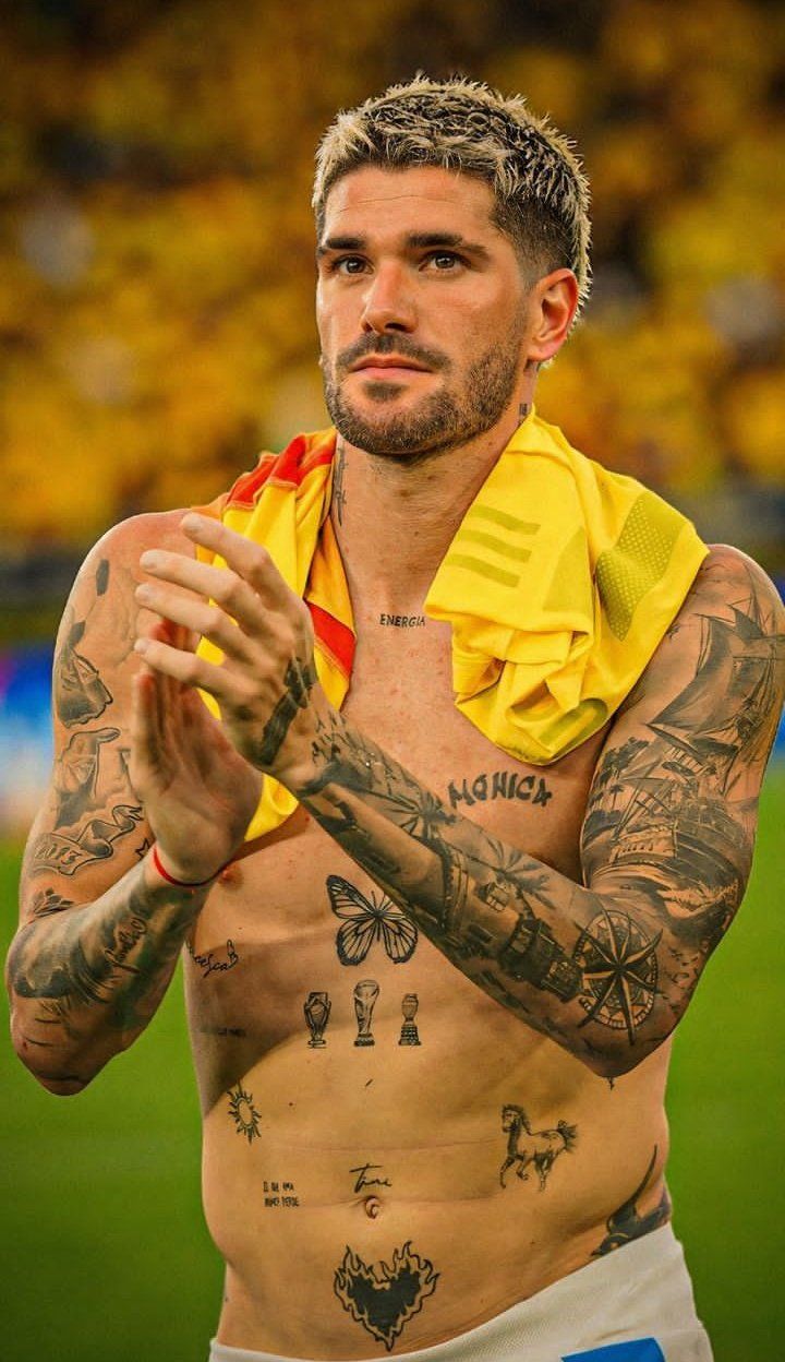 Rodrigo De Paul tattoos: separate sharp shirtless photograph showing the chest symbols, lettering and dense arm work from a different angle