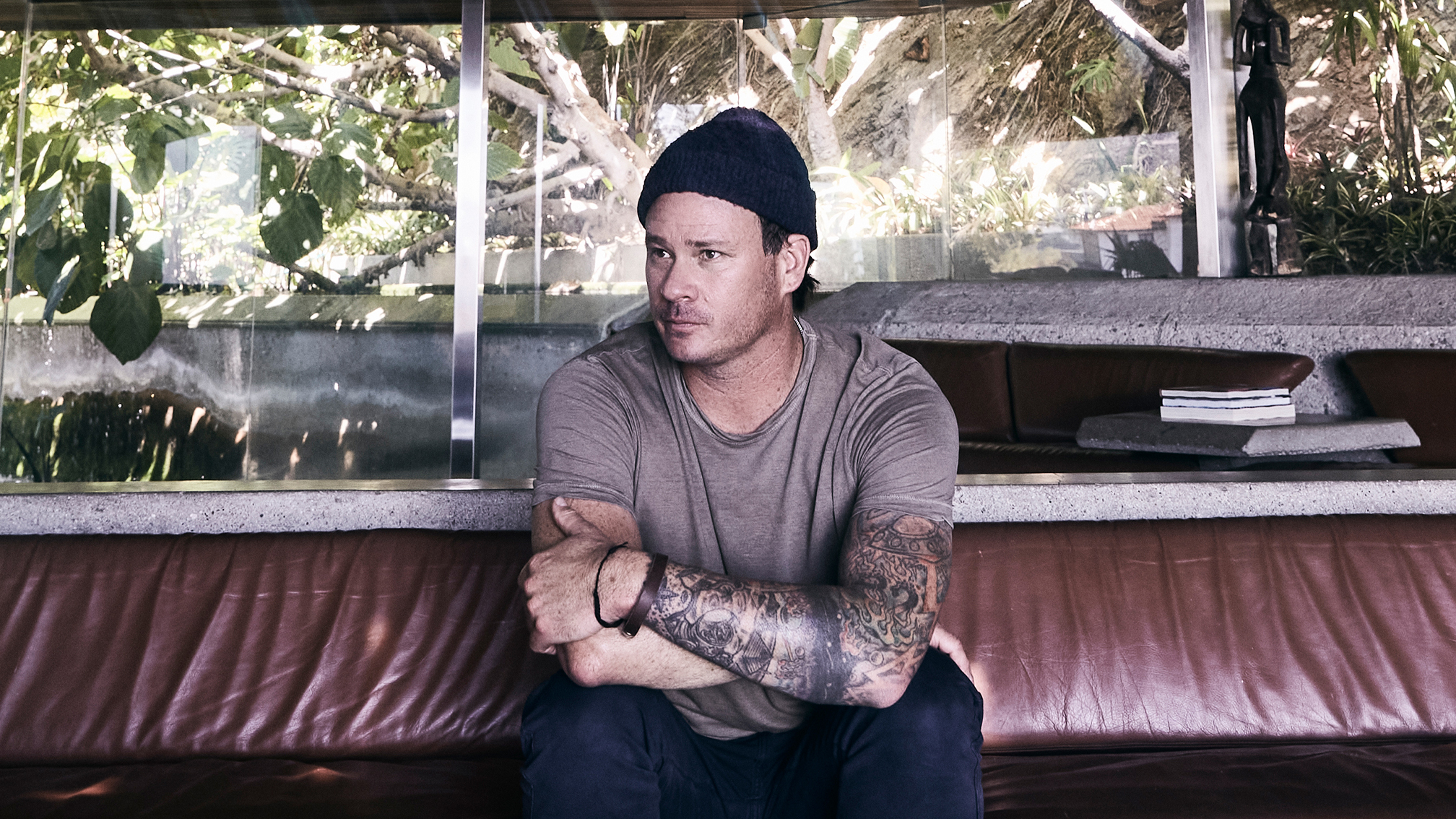 Tom DeLonge tattoos: wide interview portrait showing the layered sleeve across Tom DeLonge's forearm and upper arm