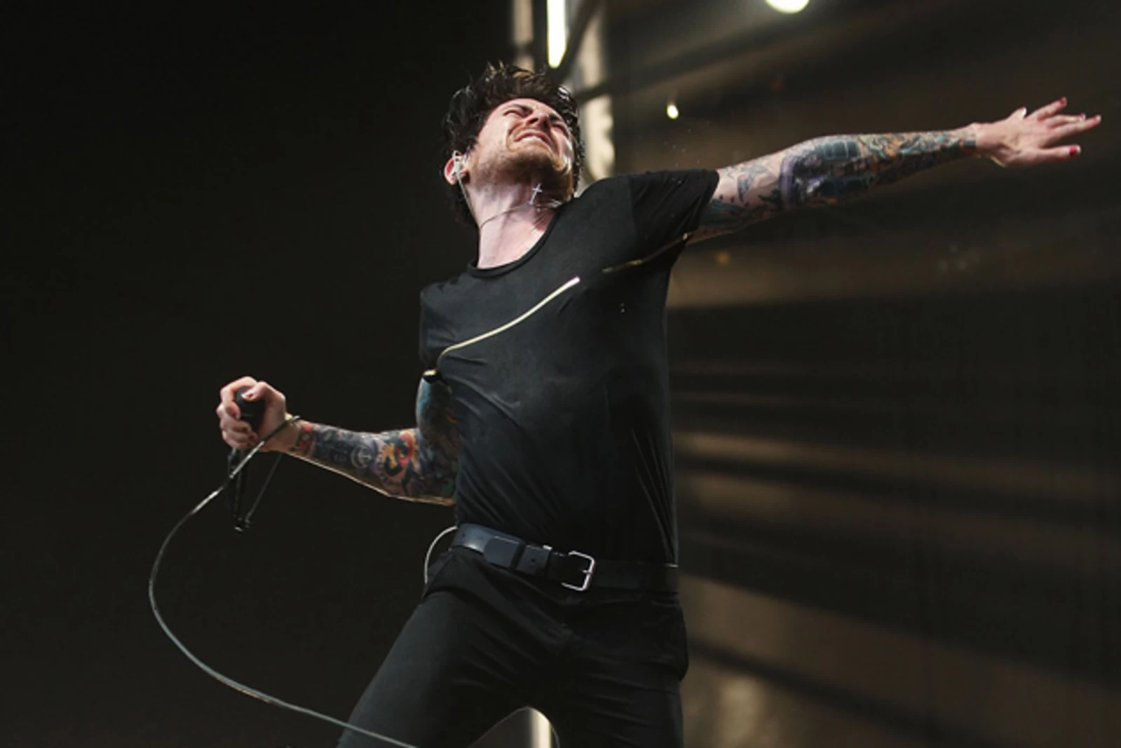 Davey Havok tattoos: large live performance photograph showing both tattooed arms and wrist details in motion
