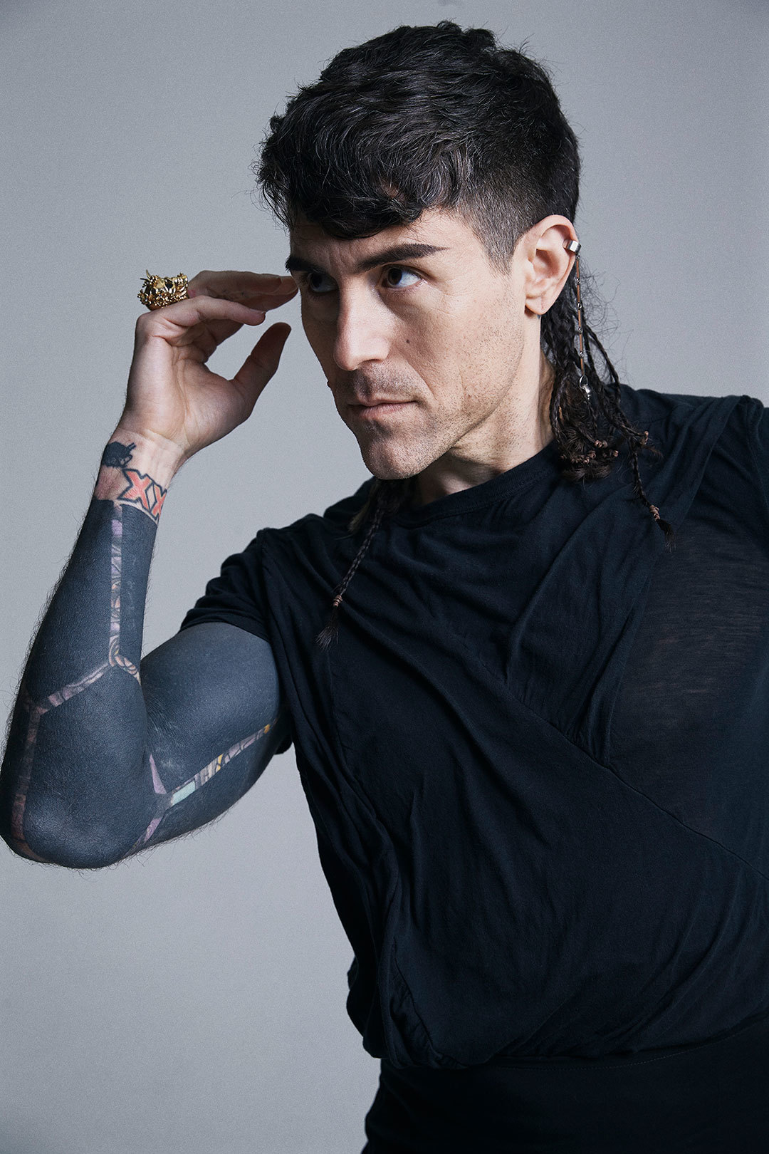 Davey Havok tattoos: modern face-visible portrait showing the current blackout sleeve texture and geometric arm bands