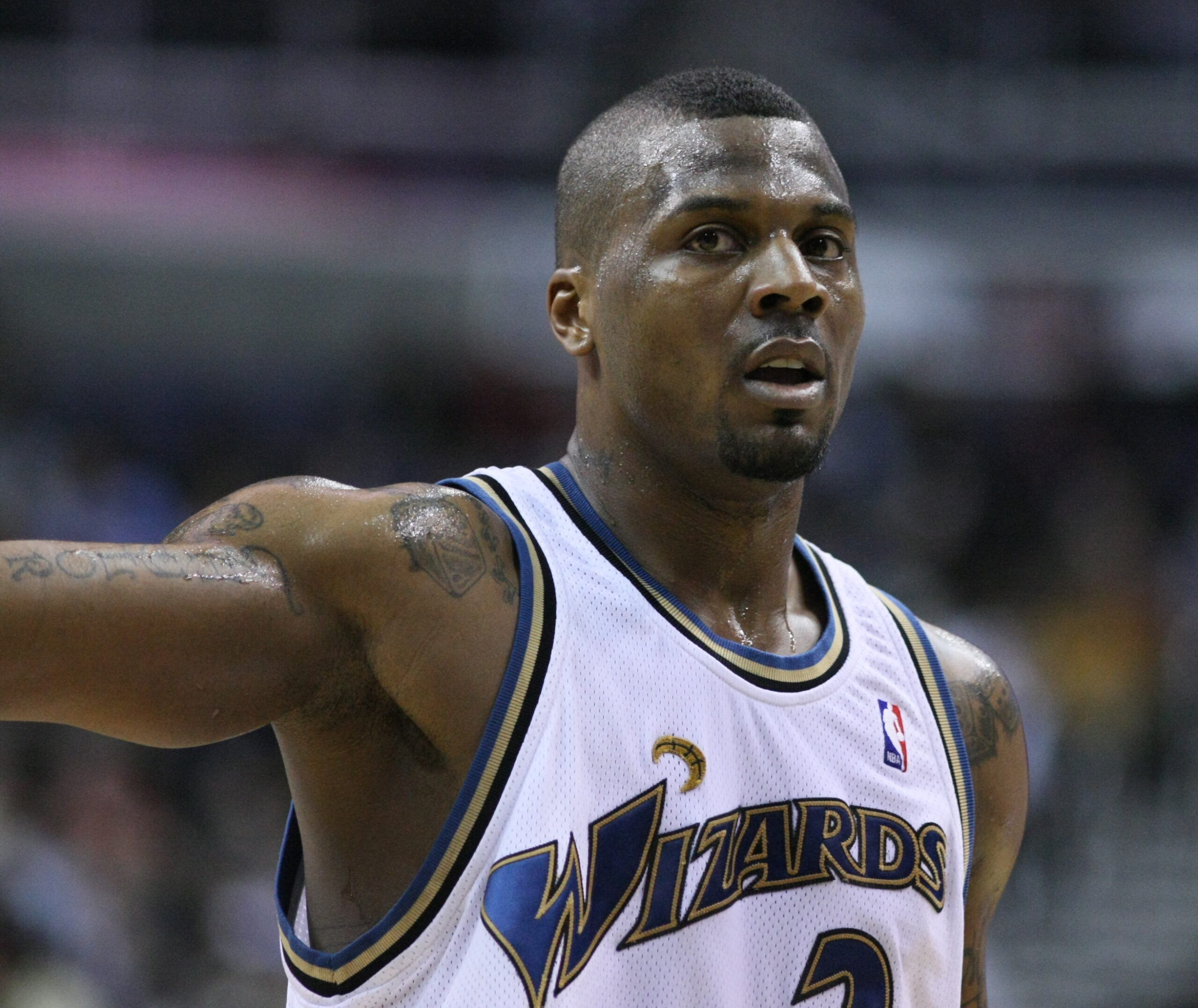 DeShawn Stevenson tattoos: high-resolution action portrait showing the shoulder and upper-arm tattoos