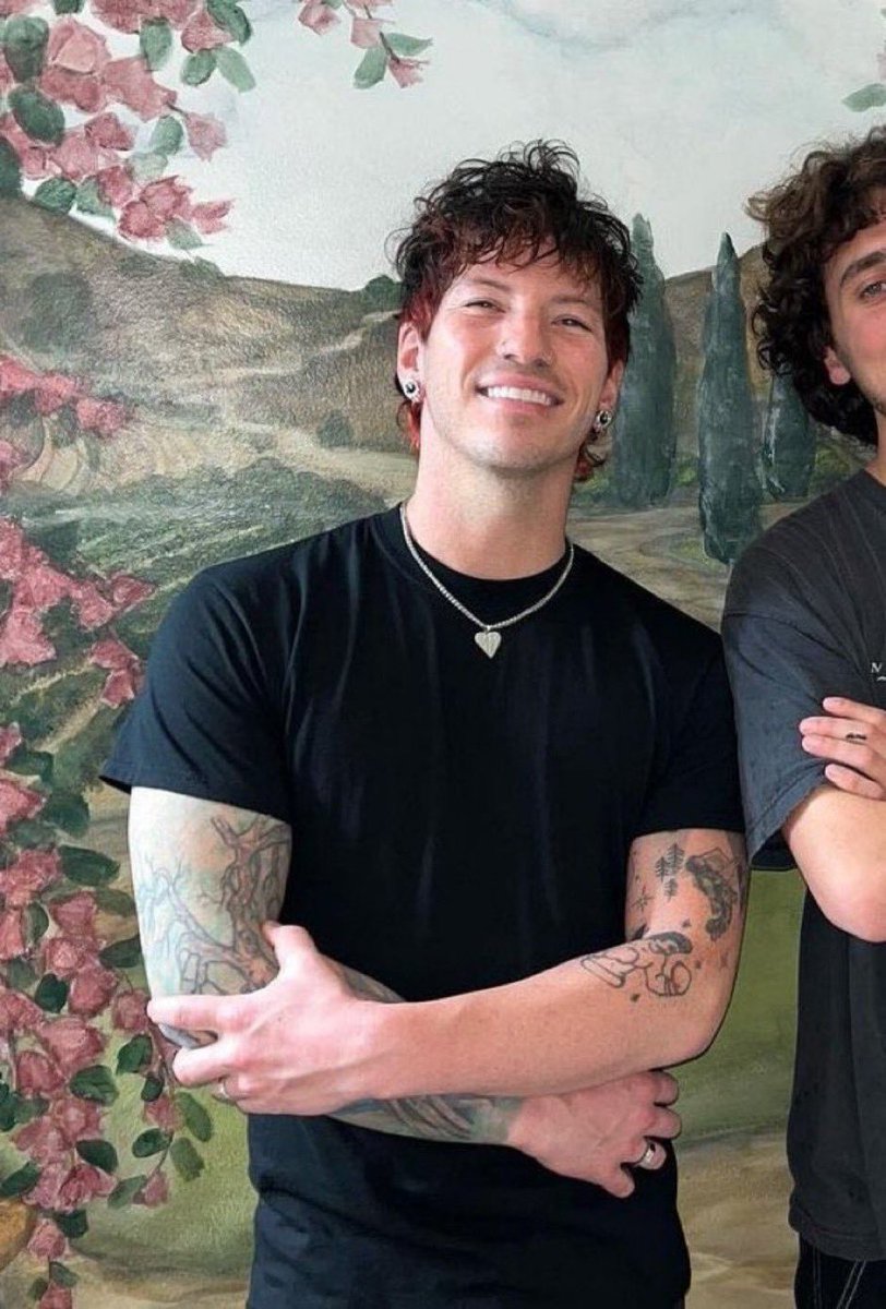 Josh Dun tattoos: portrait showing both tattooed forearms and the separate pieces around the wrists