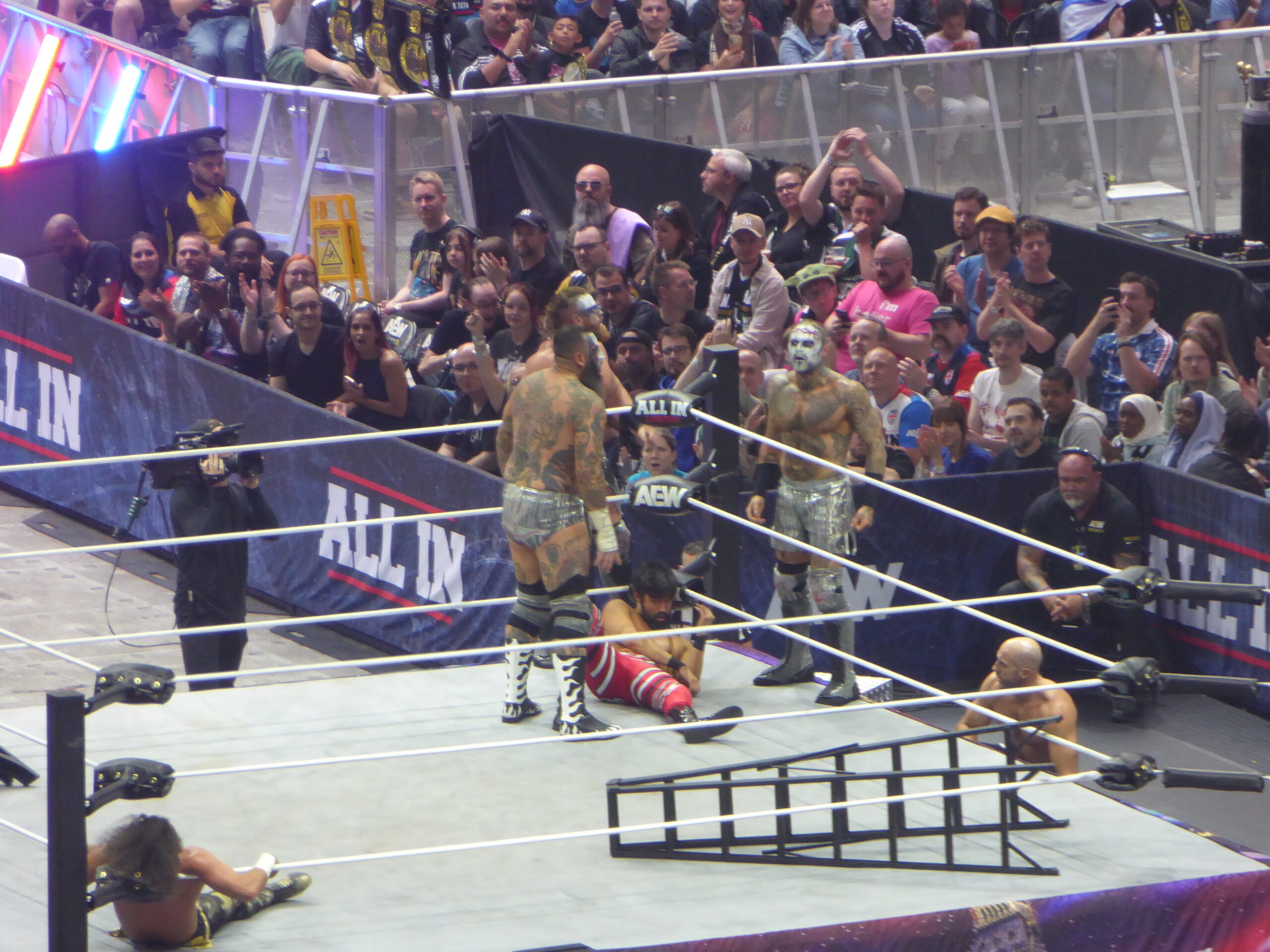 Brody King tattoos: high-resolution event photograph showing the large back tattoo from behind during the House of Black entrance