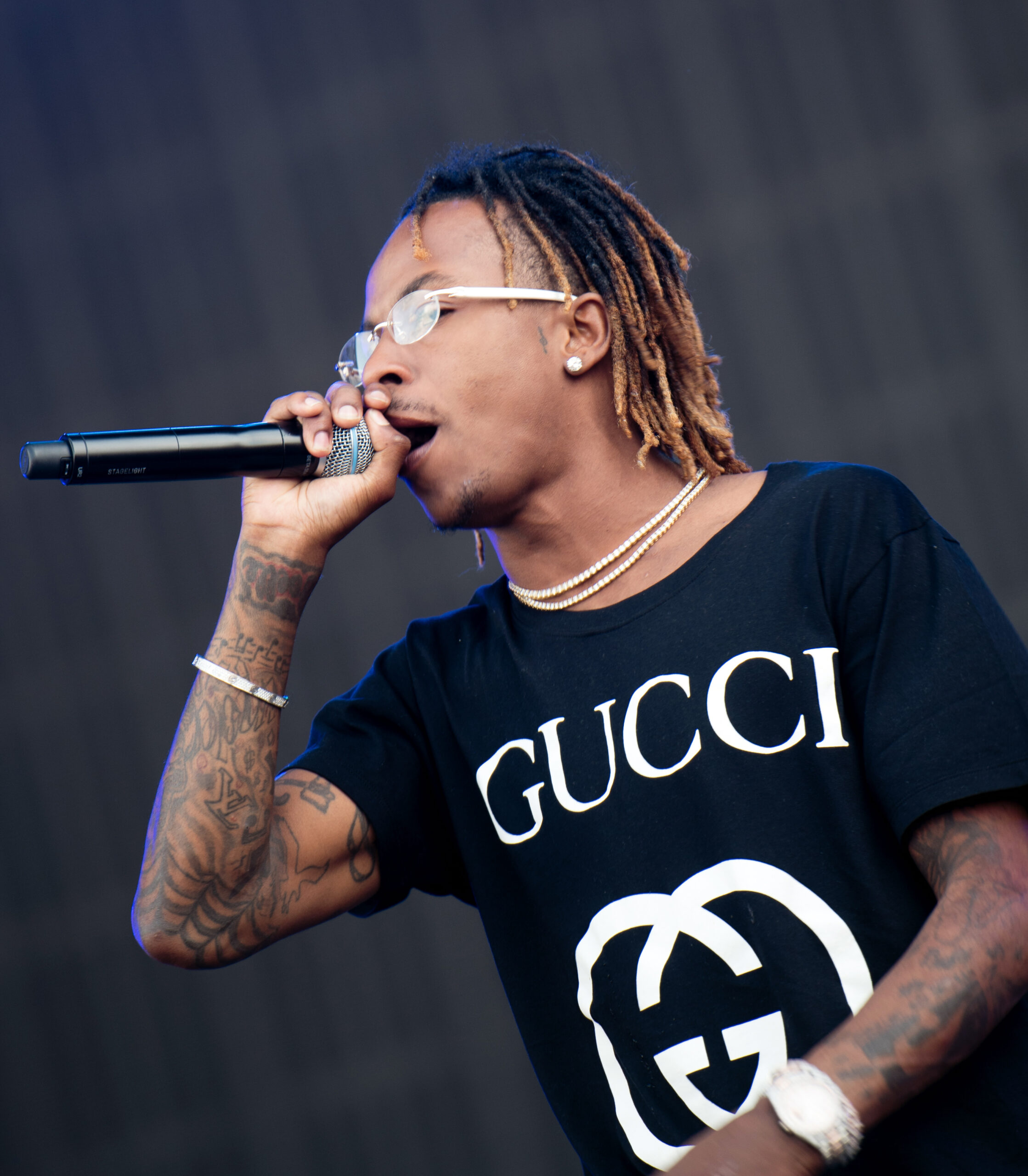 Rich The Kid tattoos: festival view of the visible forearm tattoo layout