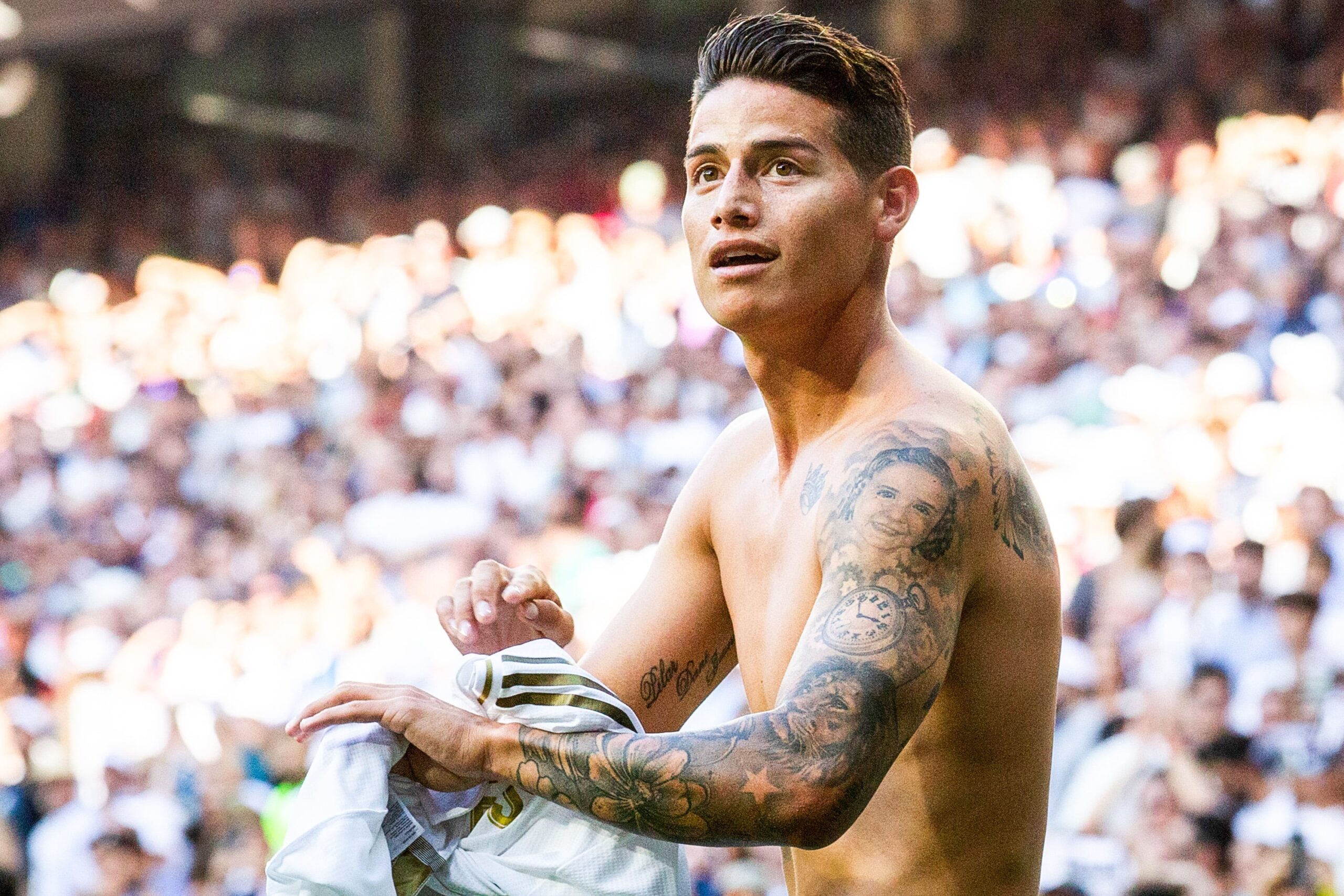 James Rodríguez tattoos: high-resolution shirtless view of the portrait and clock details on the arm