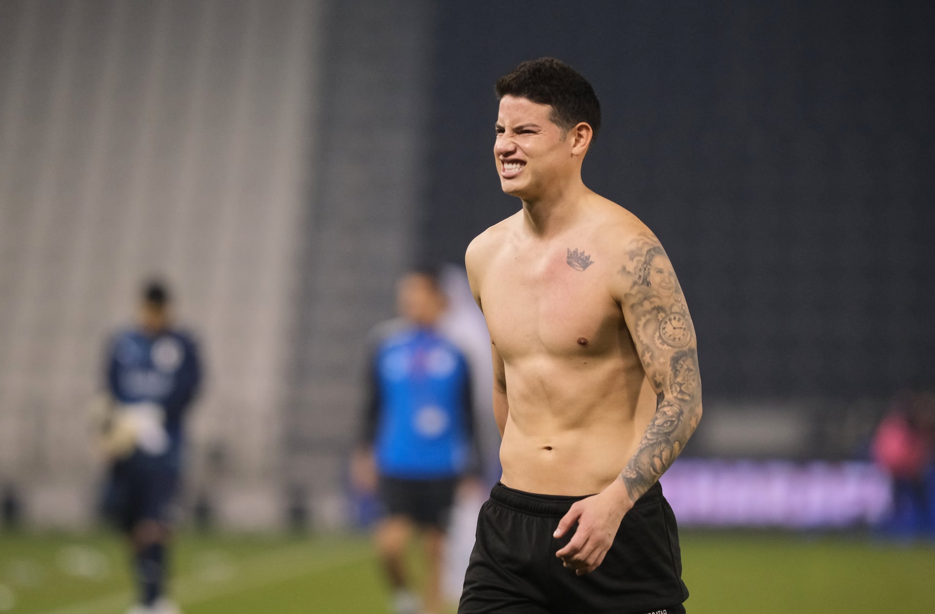James Rodríguez tattoos: high-resolution shirtless view of the crown and upper-arm portrait work