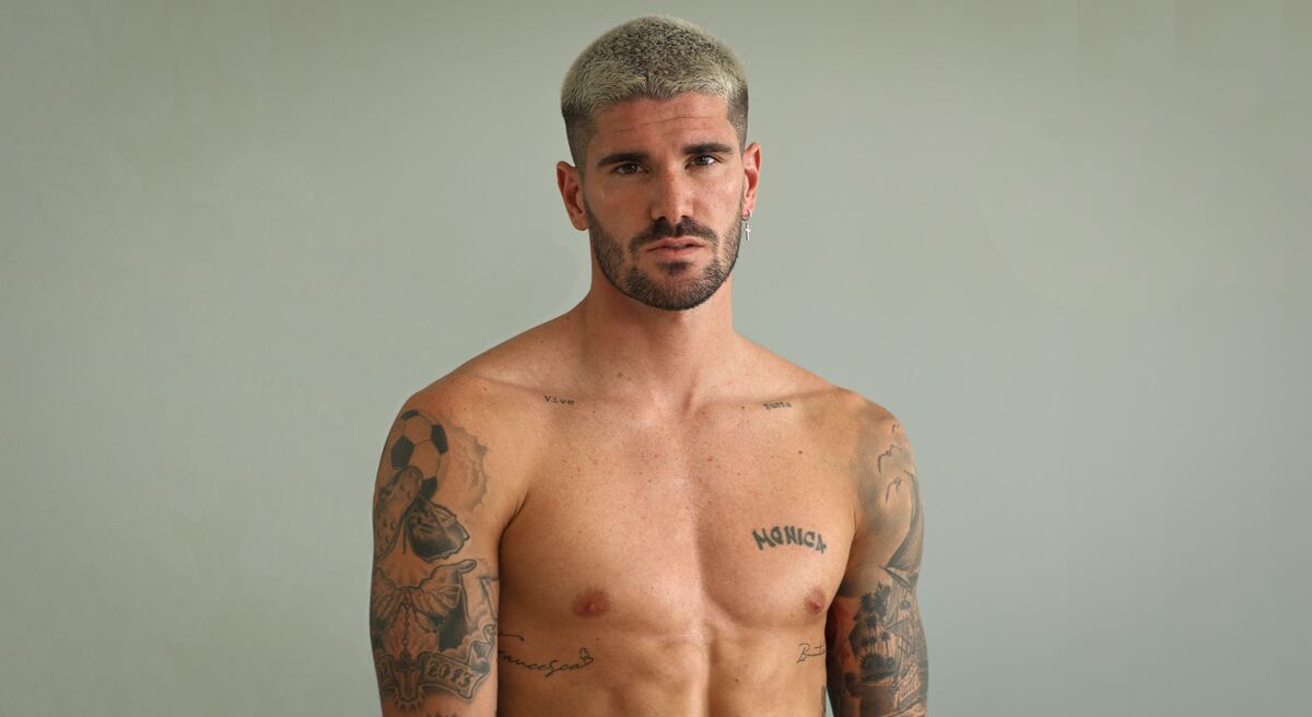 Rodrigo De Paul tattoos: wide clean torso photograph making the Monica script, chest marks and layered arm designs easy to compare