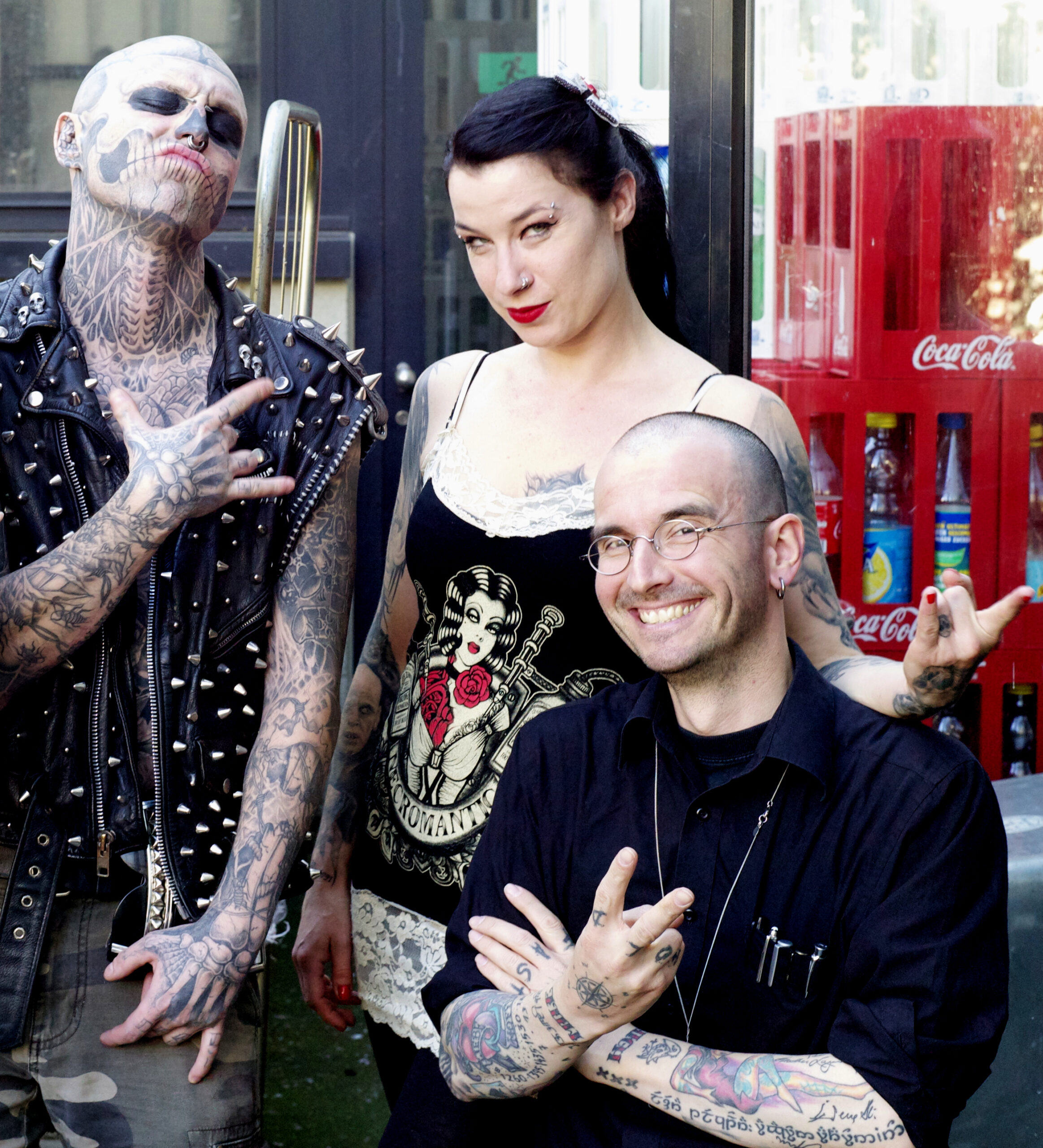 Rick Genest tattoos: high-resolution documentary photograph showing the tattooed forearms, hands, fingers, neck and skull face in a public setting