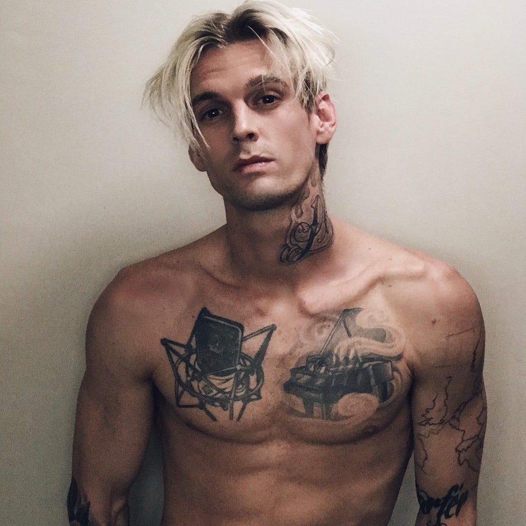 Aaron Carter microphone and chest tattoos