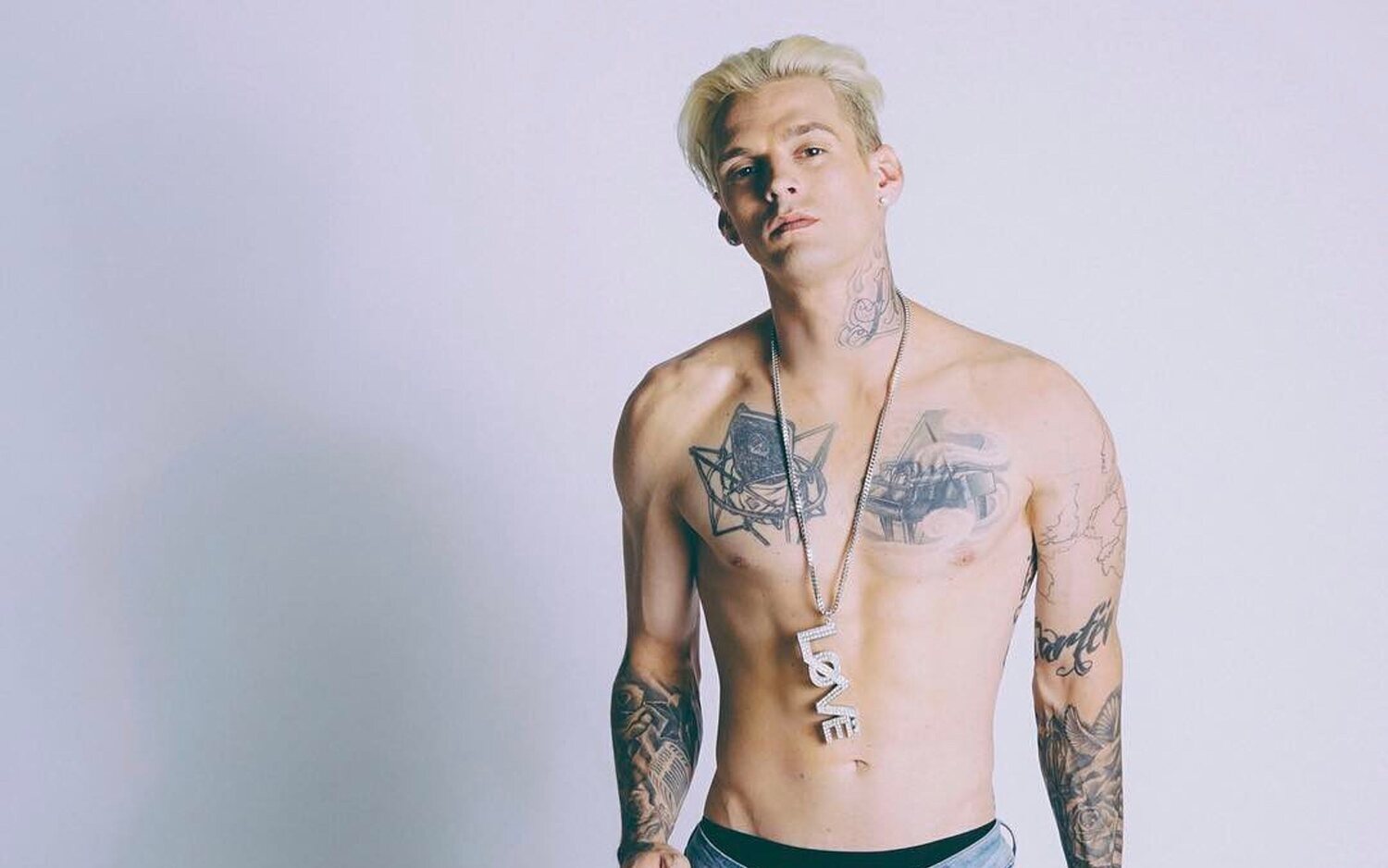 Aaron Carter grand piano and torso tattoos