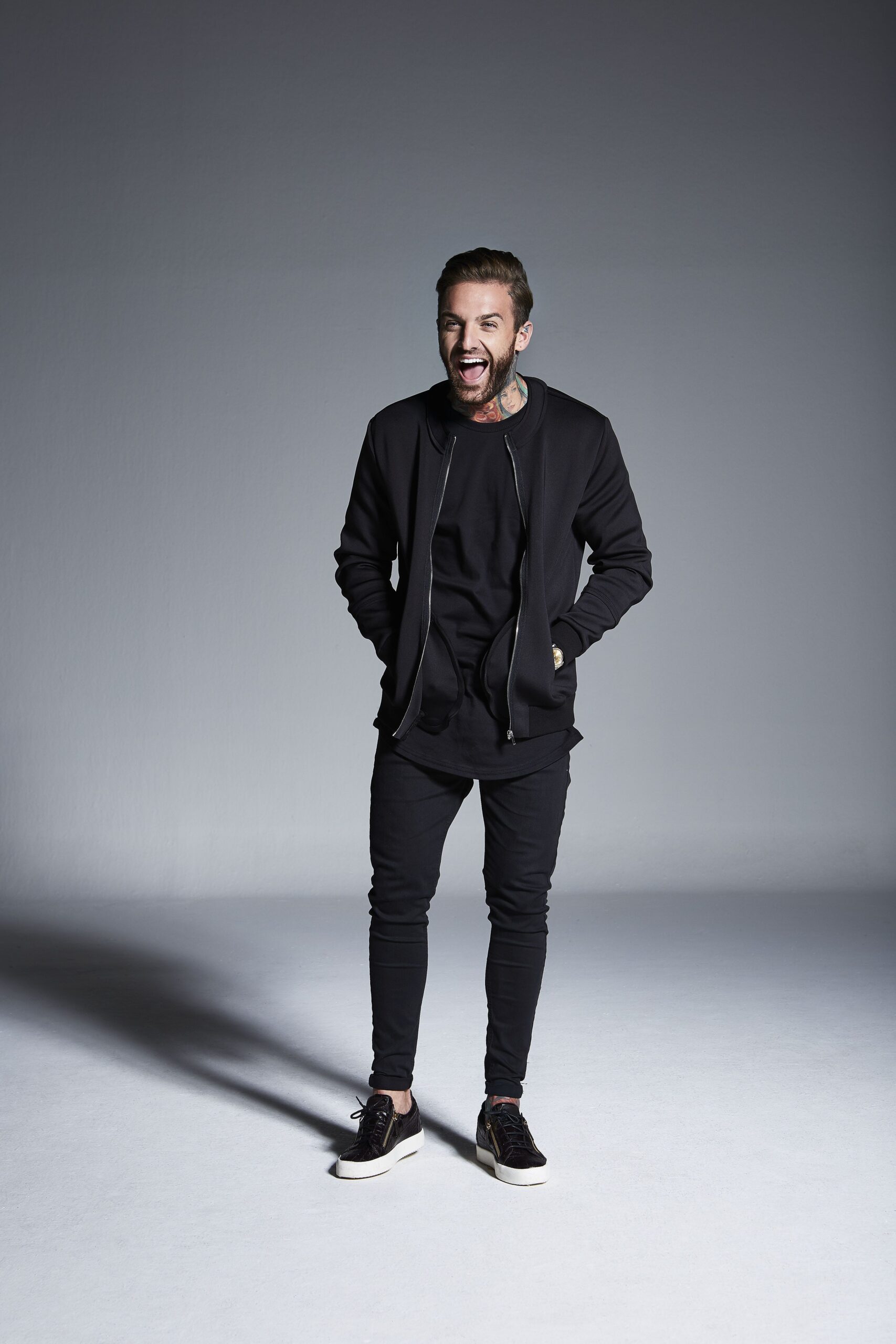 Aaron Chalmers tattoos: Distinct Digital Spy portrait showing the visible neck tattoo and later public styling