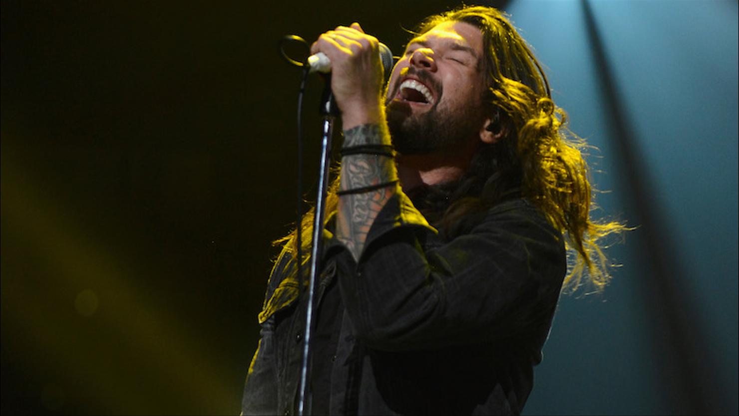 Adam Lazzara tattooed forearm during a live performance