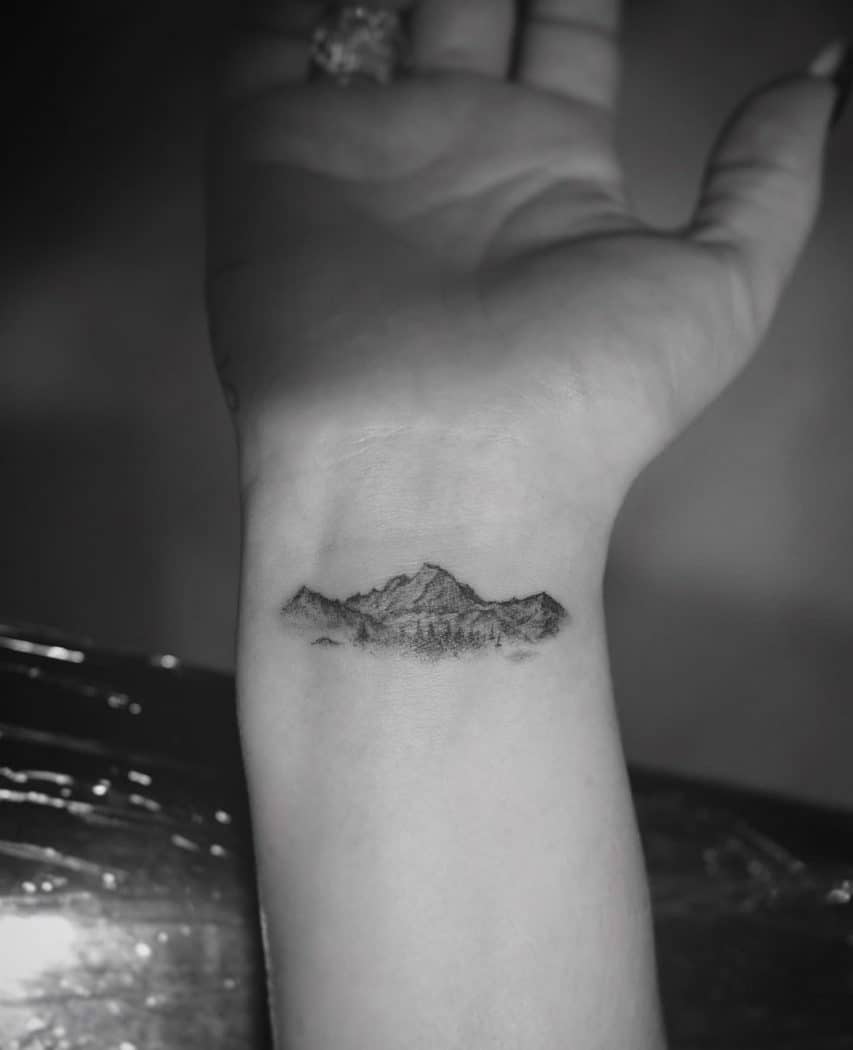 Adele mountain wrist tattoo