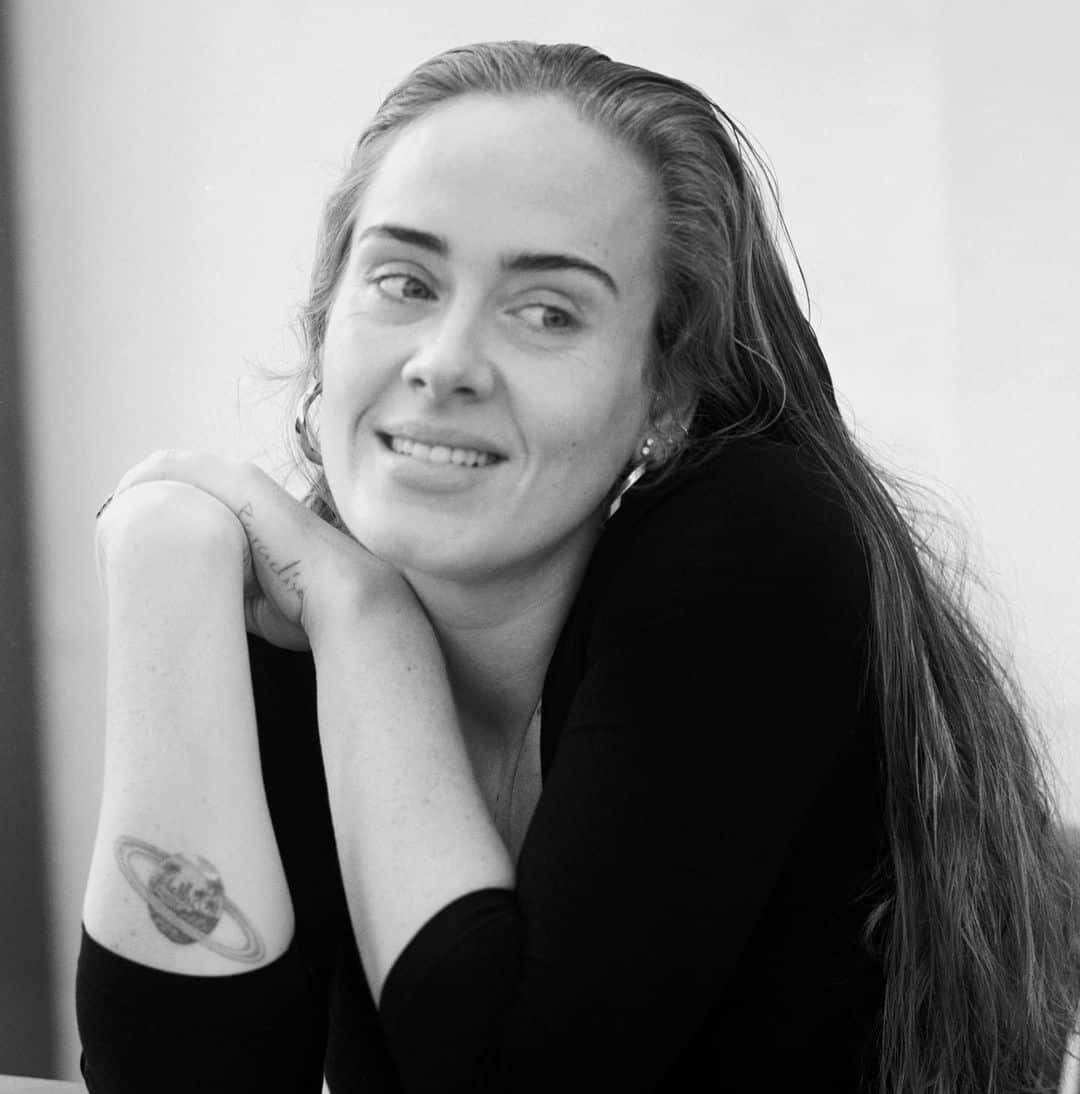 Adele Saturn and hand tattoos
