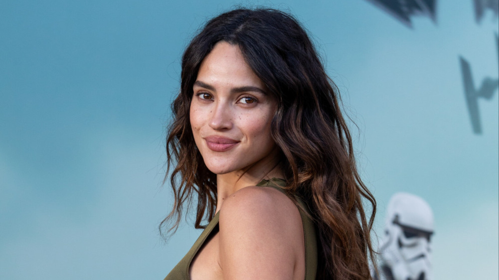 Adria Arjona in a contextual photograph: Adria Arjona promotional portrait; not tattoo evidence