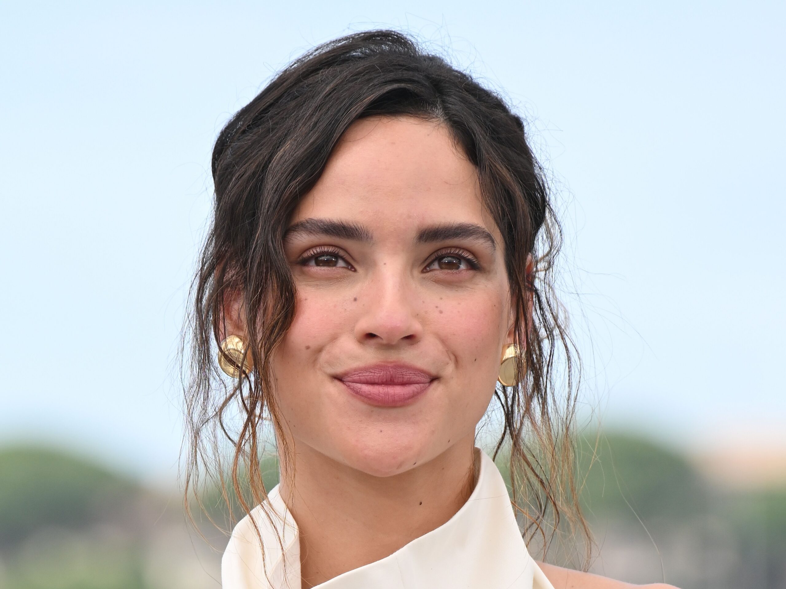 Adria Arjona in a contextual photograph: Adria Arjona Vogue portrait; not tattoo evidence