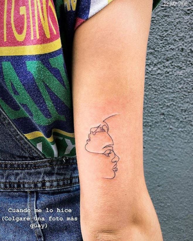 Aitana Ocaña tattoos: two opposing faces line tattoo