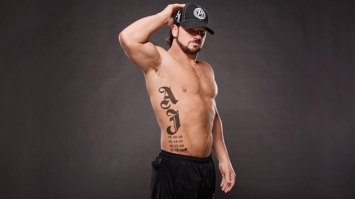 AJ Styles tattoos: inline wide view of AJ lettering and dates