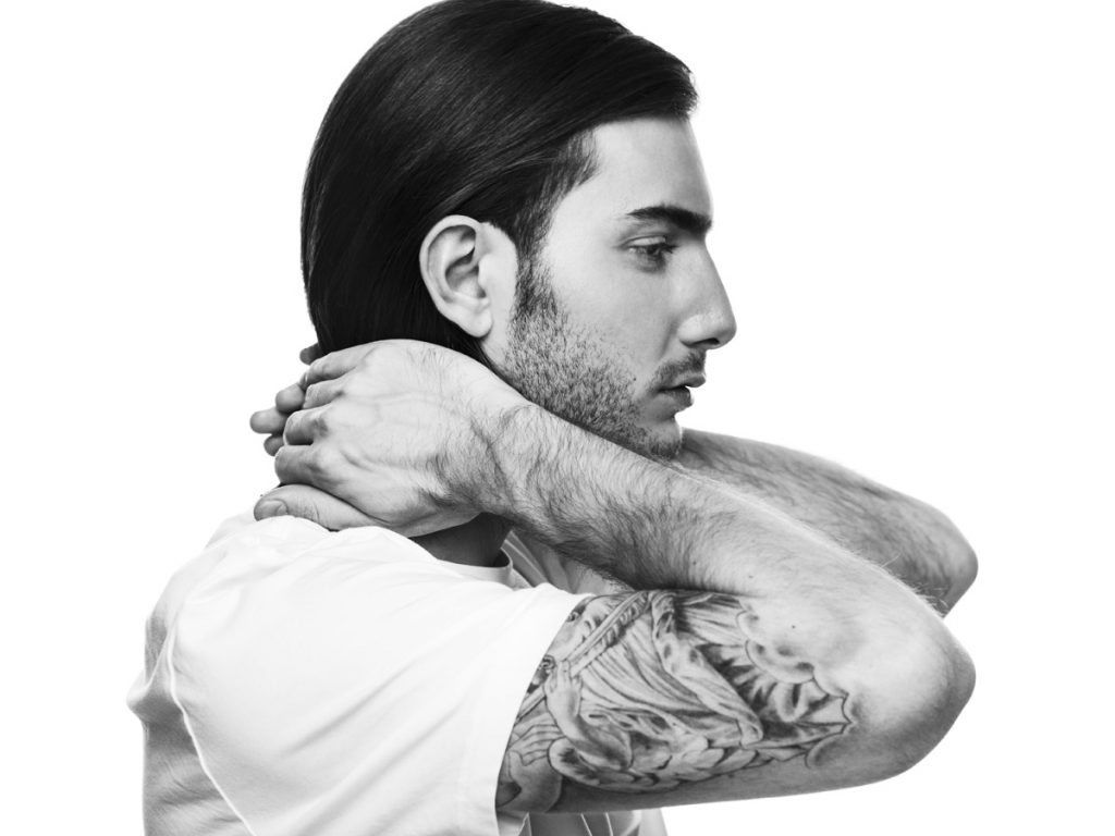 Alesso tattoos: forearm eagle and blackwork visible in side profile