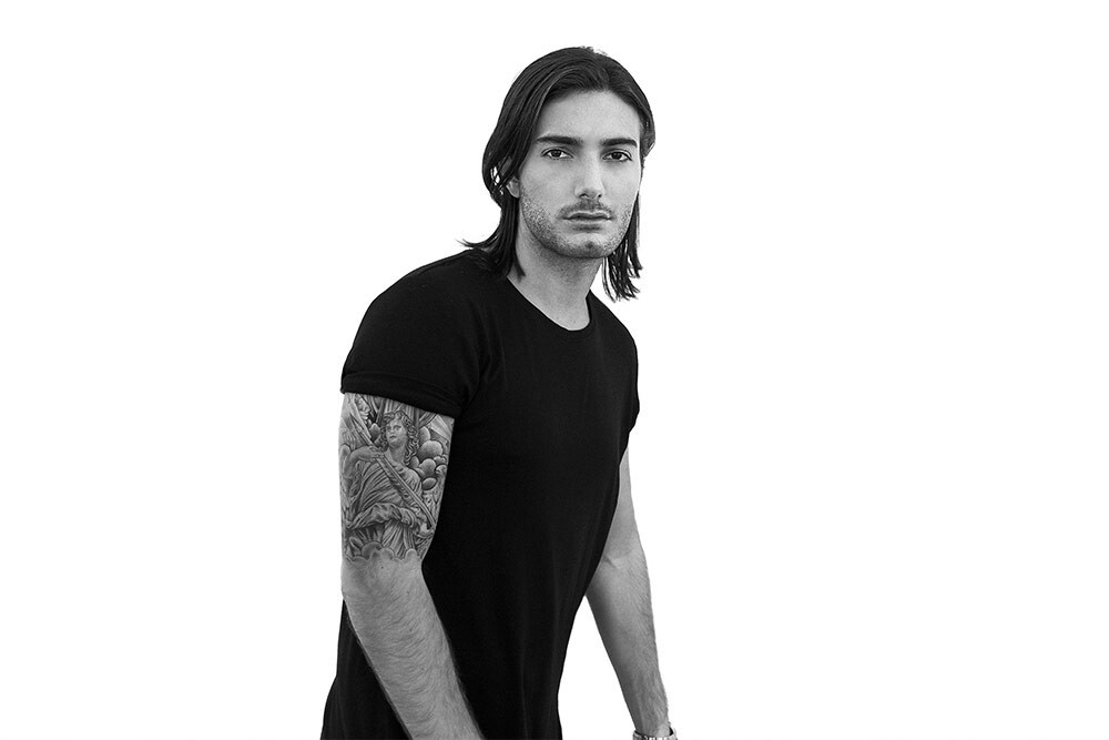 Alesso tattoos: full tattoo sleeves visible in a studio portrait
