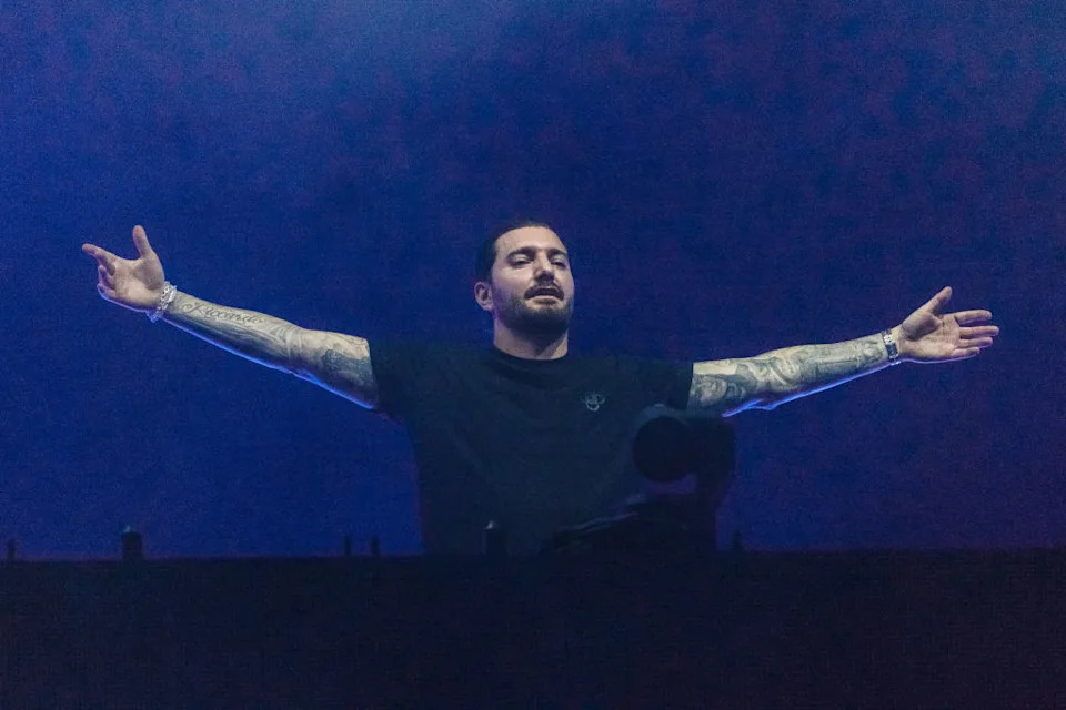 Alesso tattoos: both forearm sleeves shown while Alesso performs live