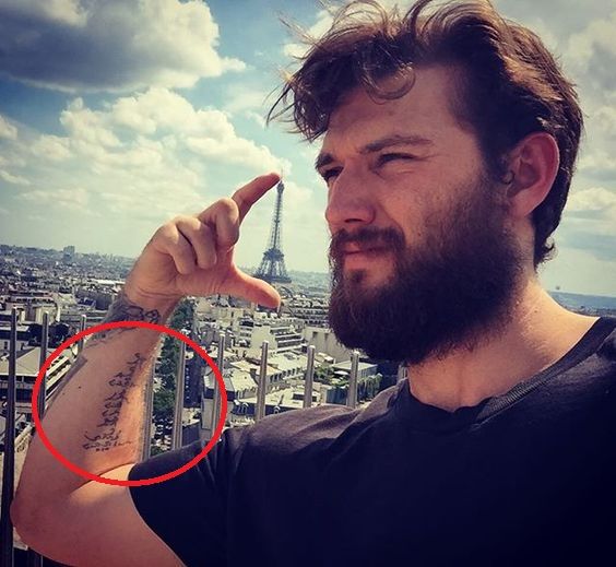 Alex Pettyfer Arabic forearm script tattoo