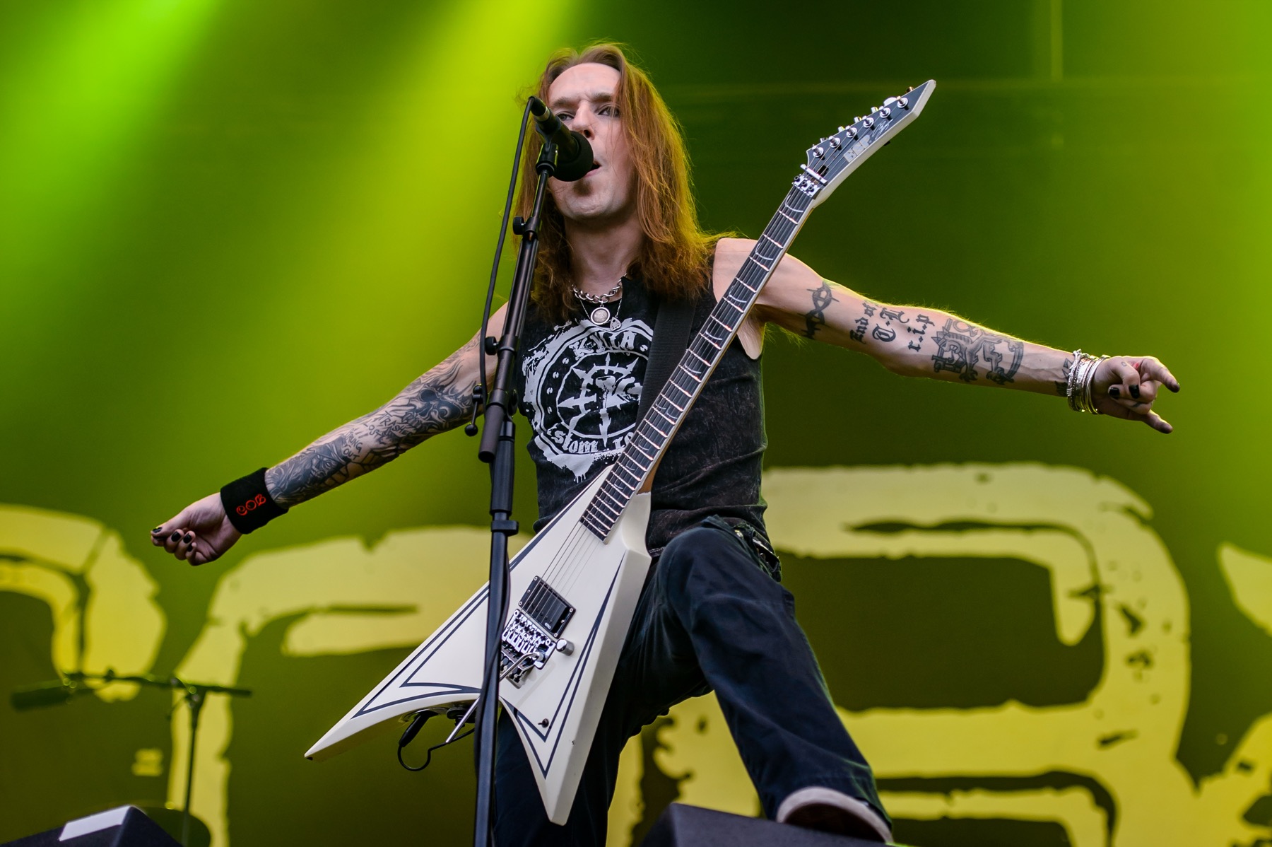 Alexi Laiho's tattooed arms under concert lights