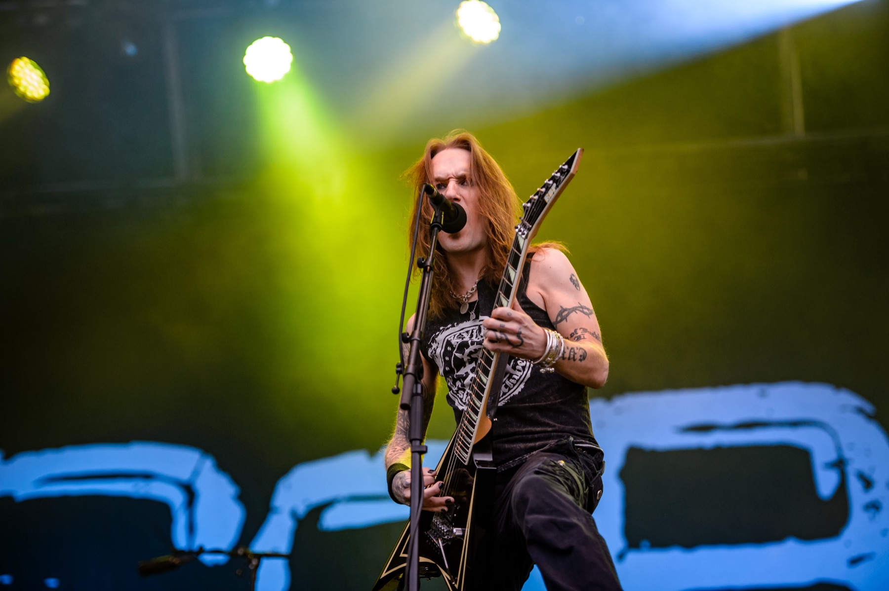 Alexi Laiho showing full arm tattoo coverage during a performance