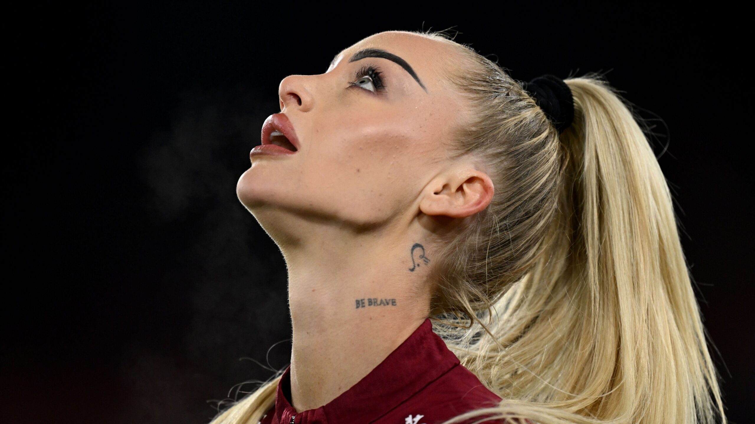 Alisha Lehmann tattoos: Alisha Lehmann's Be Brave neck lettering in a close profile