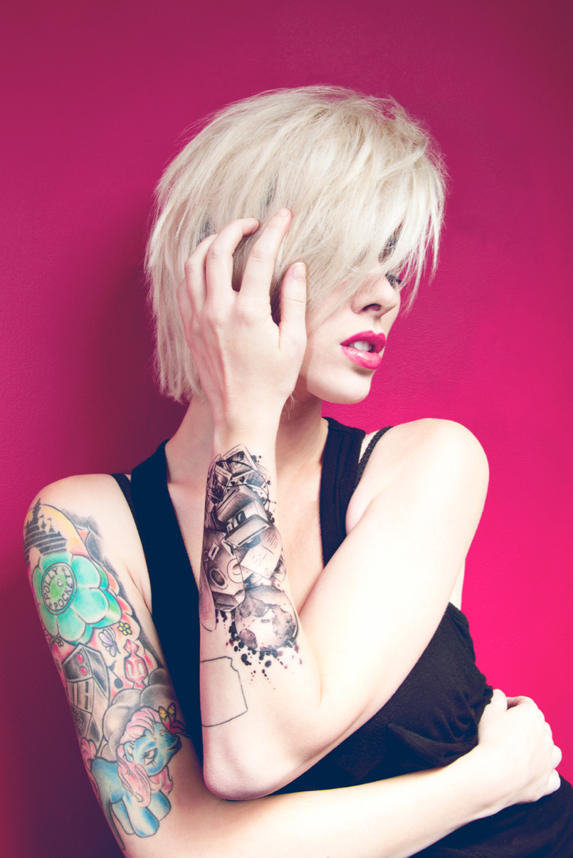 Alysha Nett color sleeve and mechanical forearm tattoos Alysha Nett tattoos: sharp color view of the arm with a large mechanical-looking forearm design, smaller linework and a visible hand mark