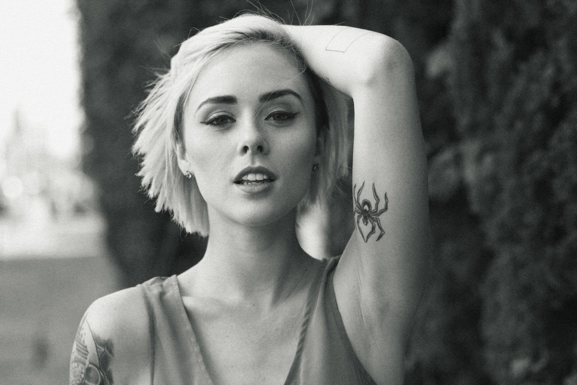 Alysha Nett monochrome spider tattoo portrait Alysha Nett tattoos: high-resolution monochrome portrait where the spider and arm composition can be read clearly without cropping away the tattoo placement