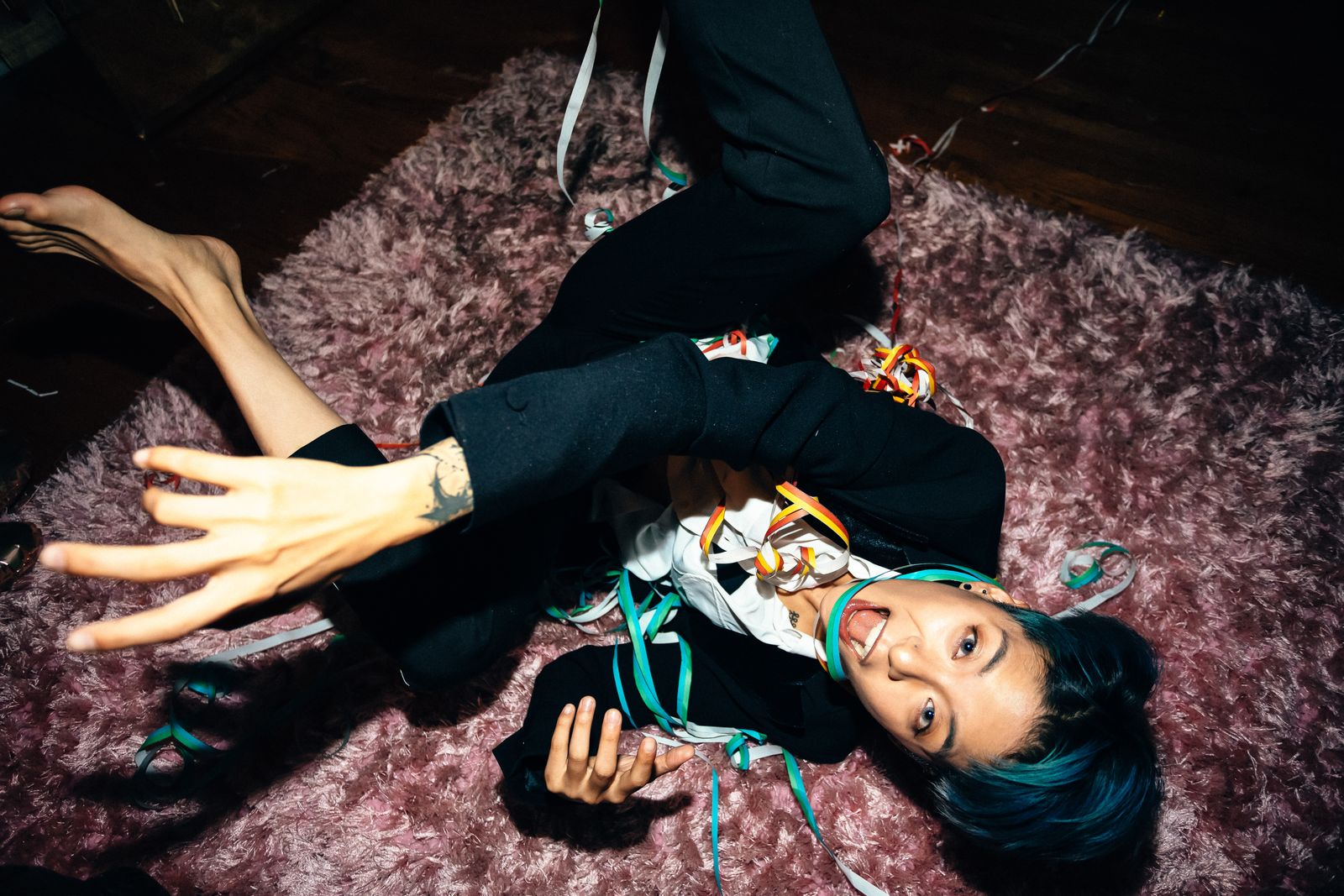 Amber Liu tattoos: close hand and wrist linework visible as the arm bends