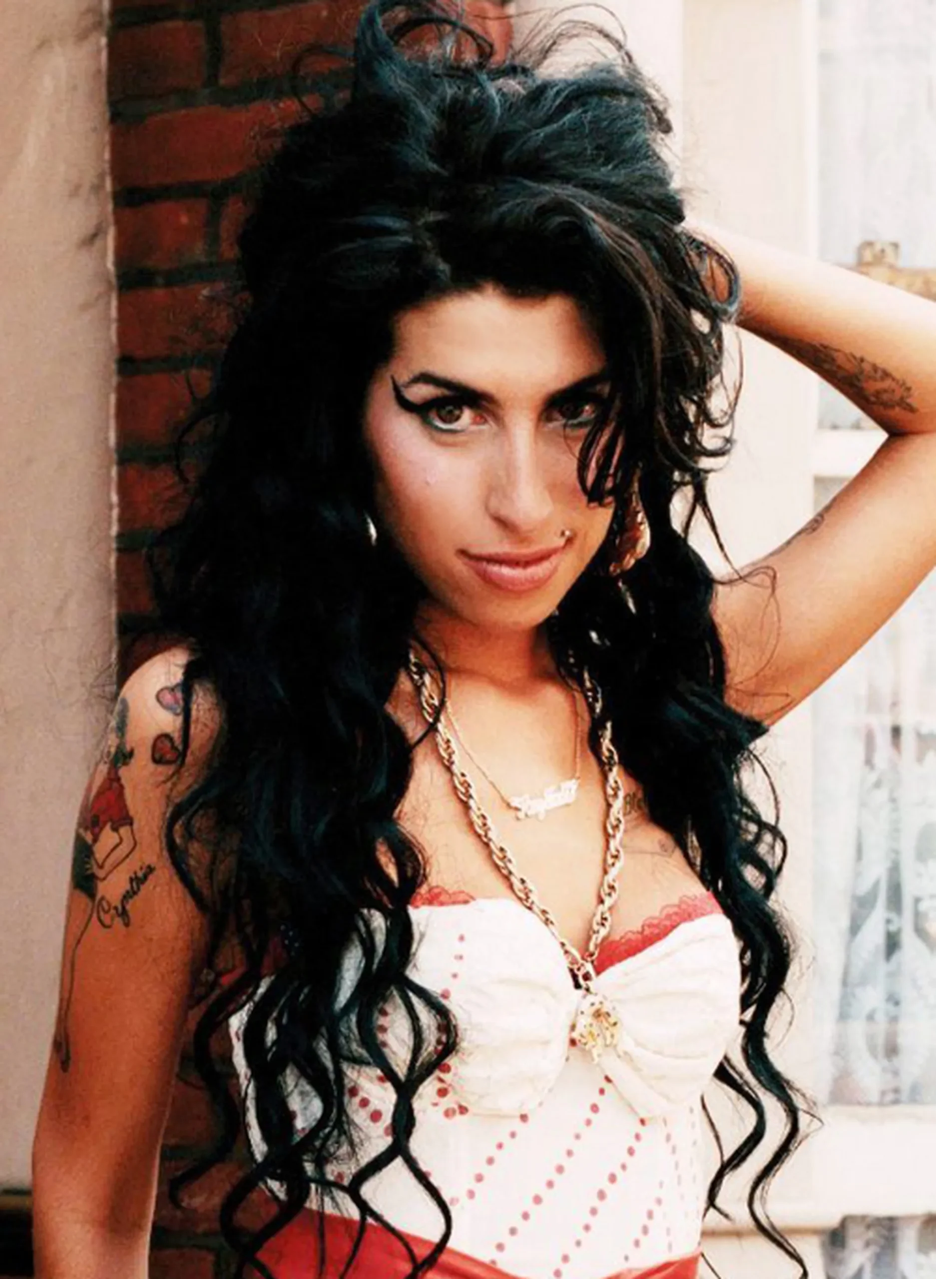 Amy Winehouse pin-up girl and Daddy's Girl horseshoe tattoos