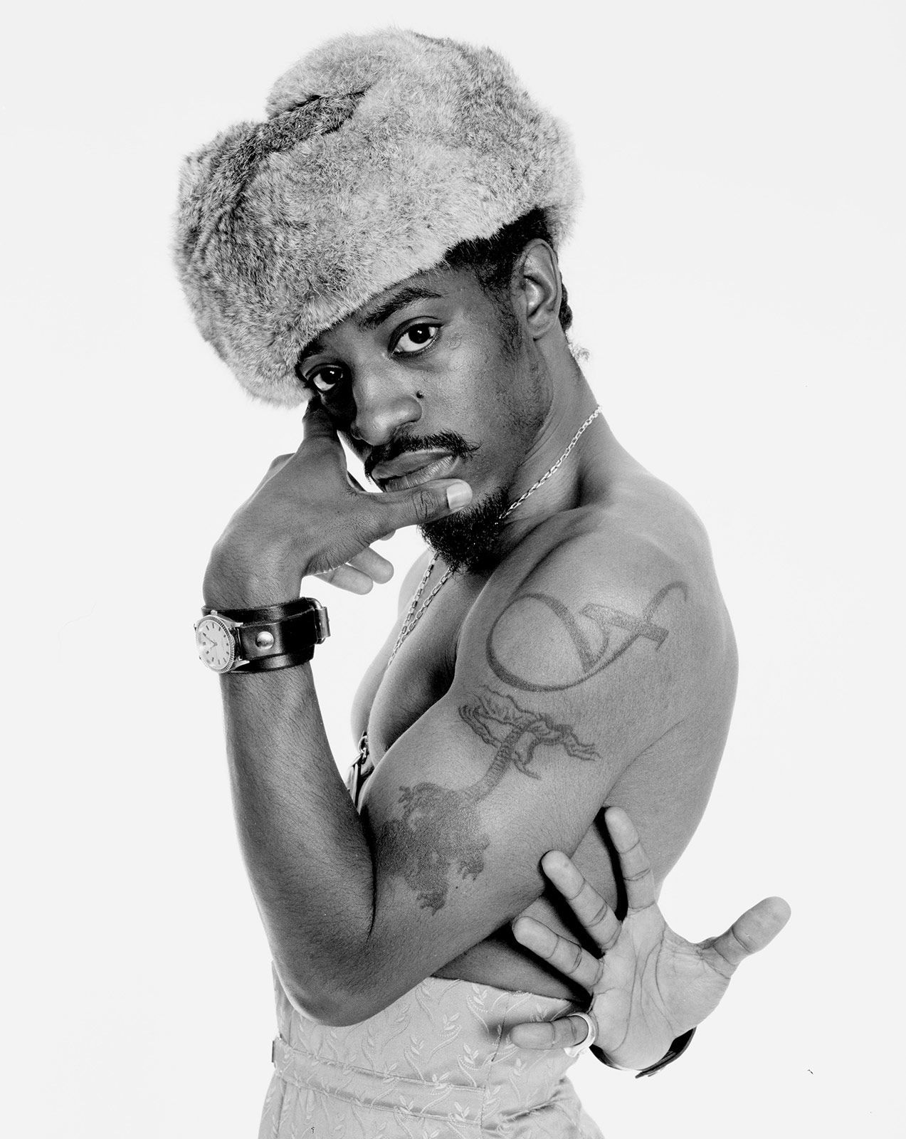 André 3000 tattoos: Close editorial view of the upper-arm tattoo forms and their spacing on André's exposed arm.