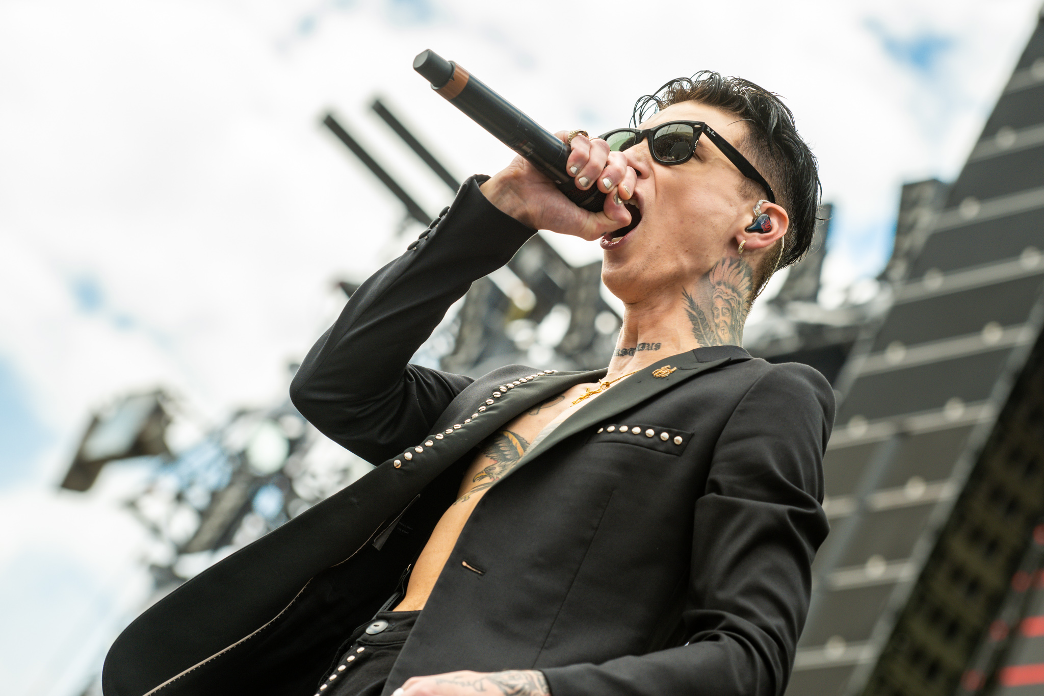 Andy Biersack torso and neck tattoos on stage
