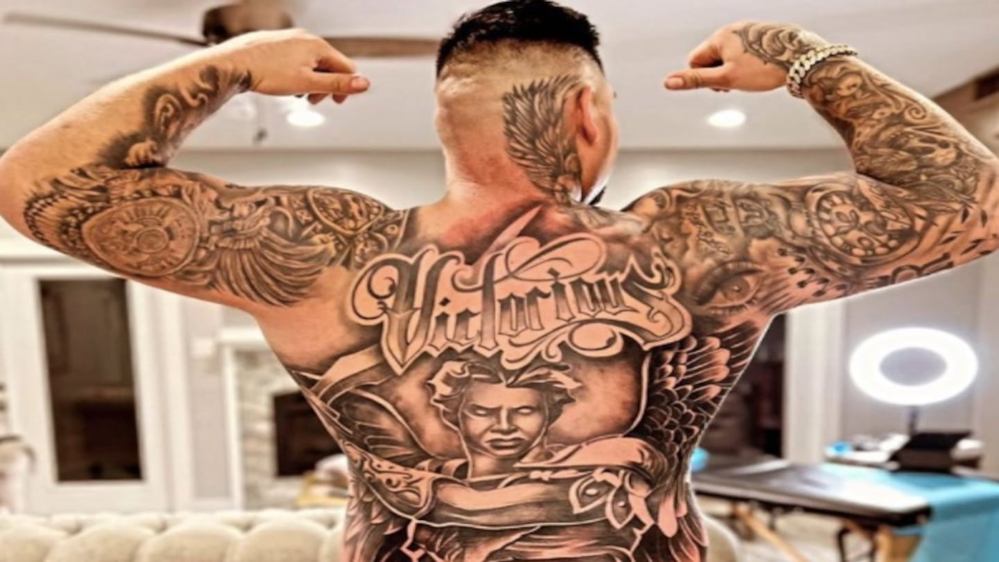 Andy Ruiz Jr. tattoos: back view showing the huge angel, Victorious lettering, neck ink, and the way the piece fills his back