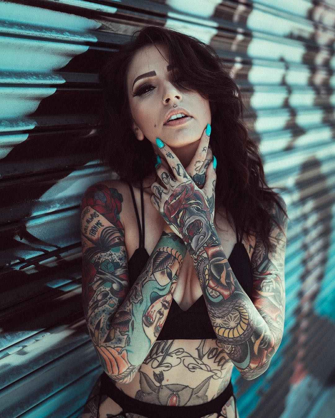 Angela Mazzanti tattoos: Cobra mouth, teeth, eye and wrist continuation sharp; opposite-hand lettering visible. No overlay or watermark. Photo texture does not obscure target.