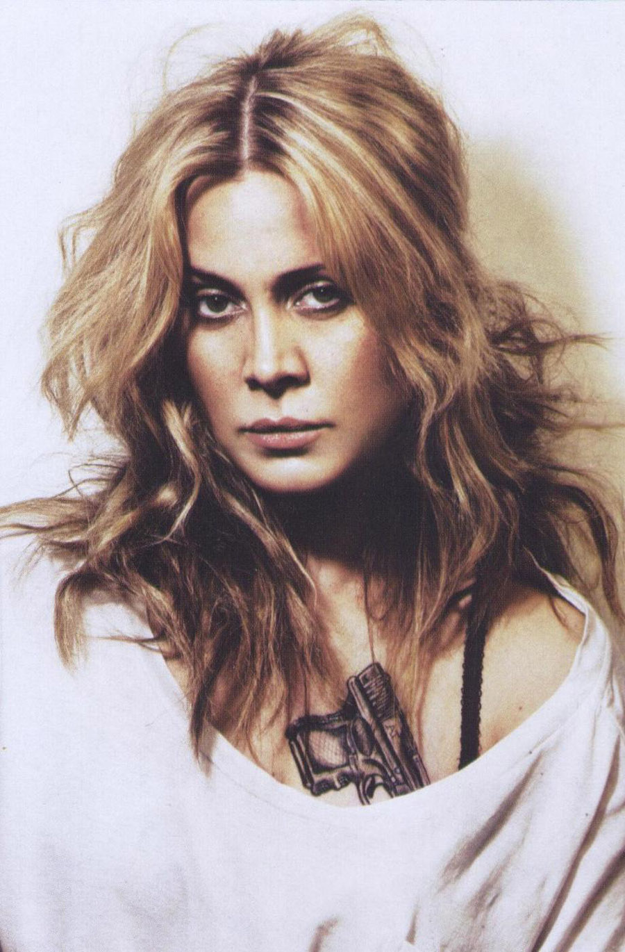 Anouk tattoos: close archival portrait showing Anouk's black gun tattoo across the upper chest