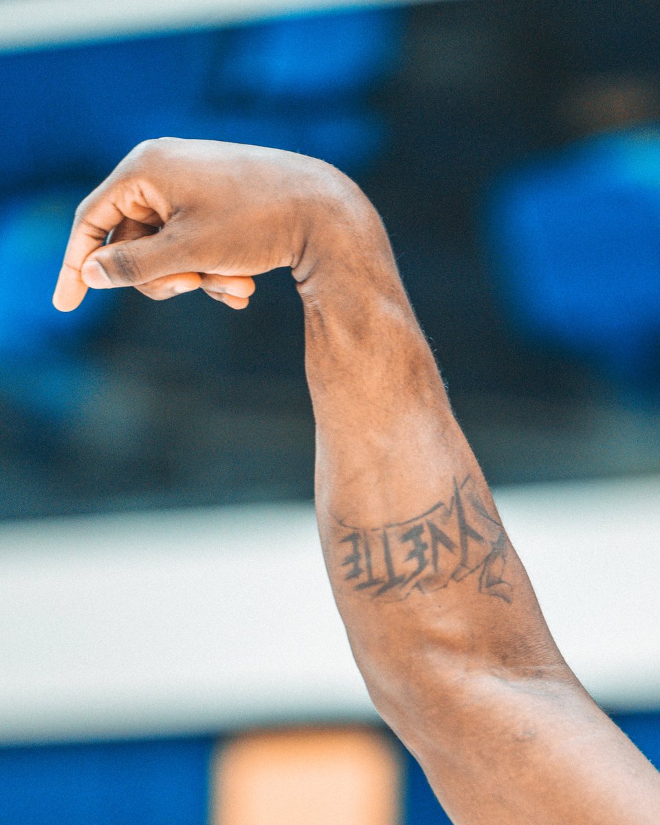 Anthony Edwards tattoos: angular forearm lettering that appears to read ELITE in his verified-account close-up; meaning not stated