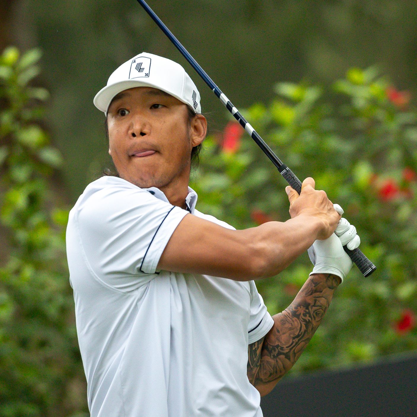 Anthony Kim tattoos: square action photo showing denser lower-arm details