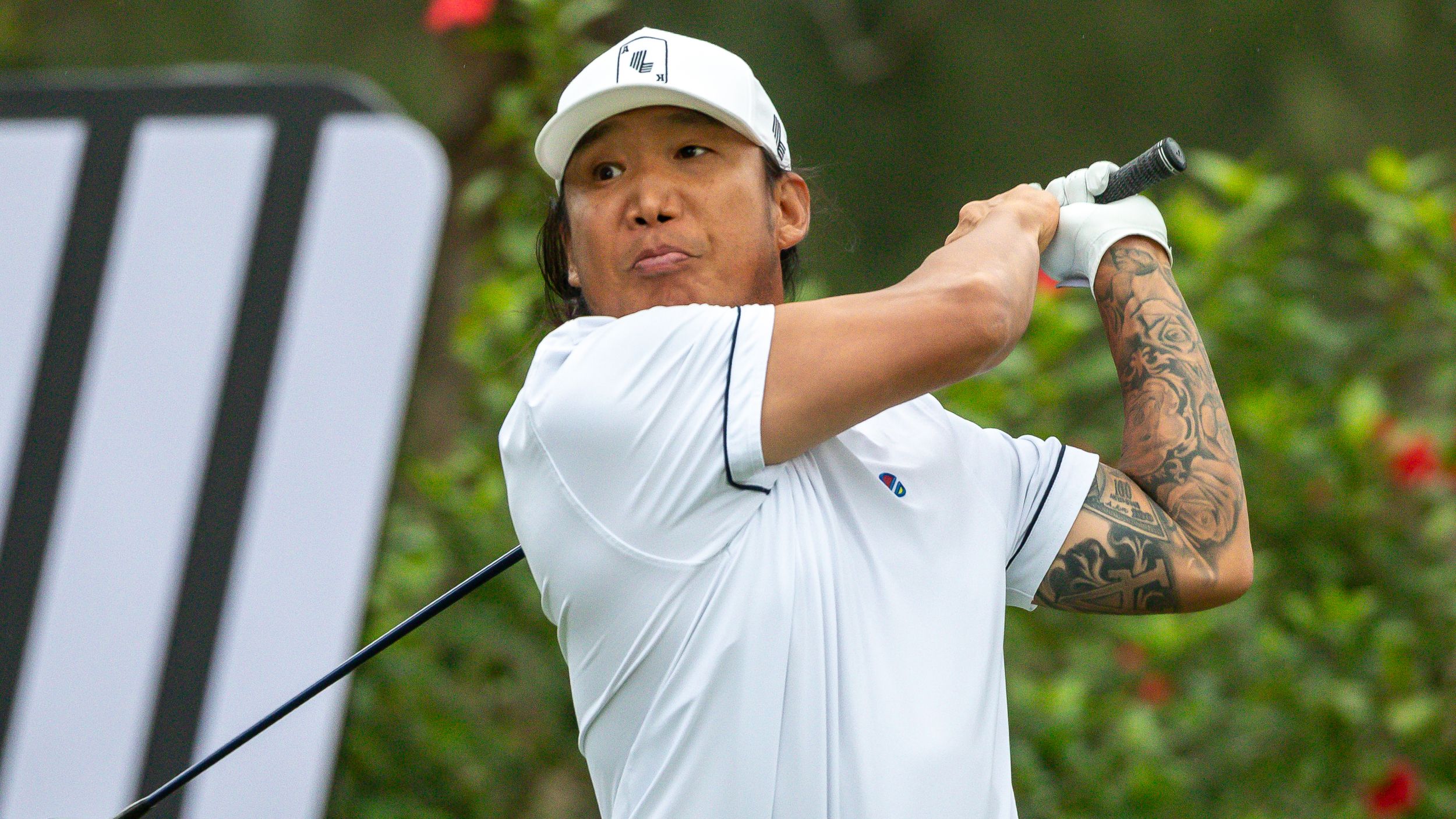 Anthony Kim tattoos: full right-arm sleeve visible during a golf swing