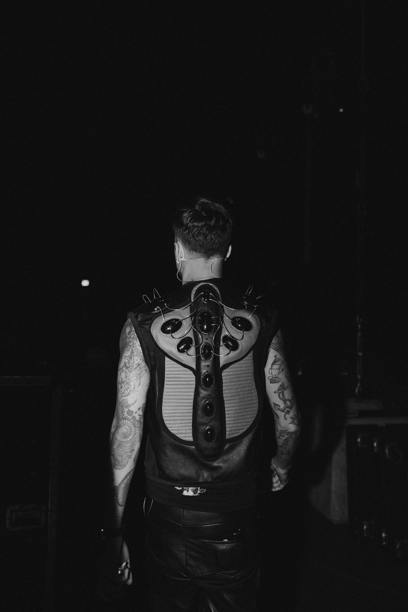 Anyma tattoos: Anyma's full back view showing the tattoo coverage and sleeve contrast