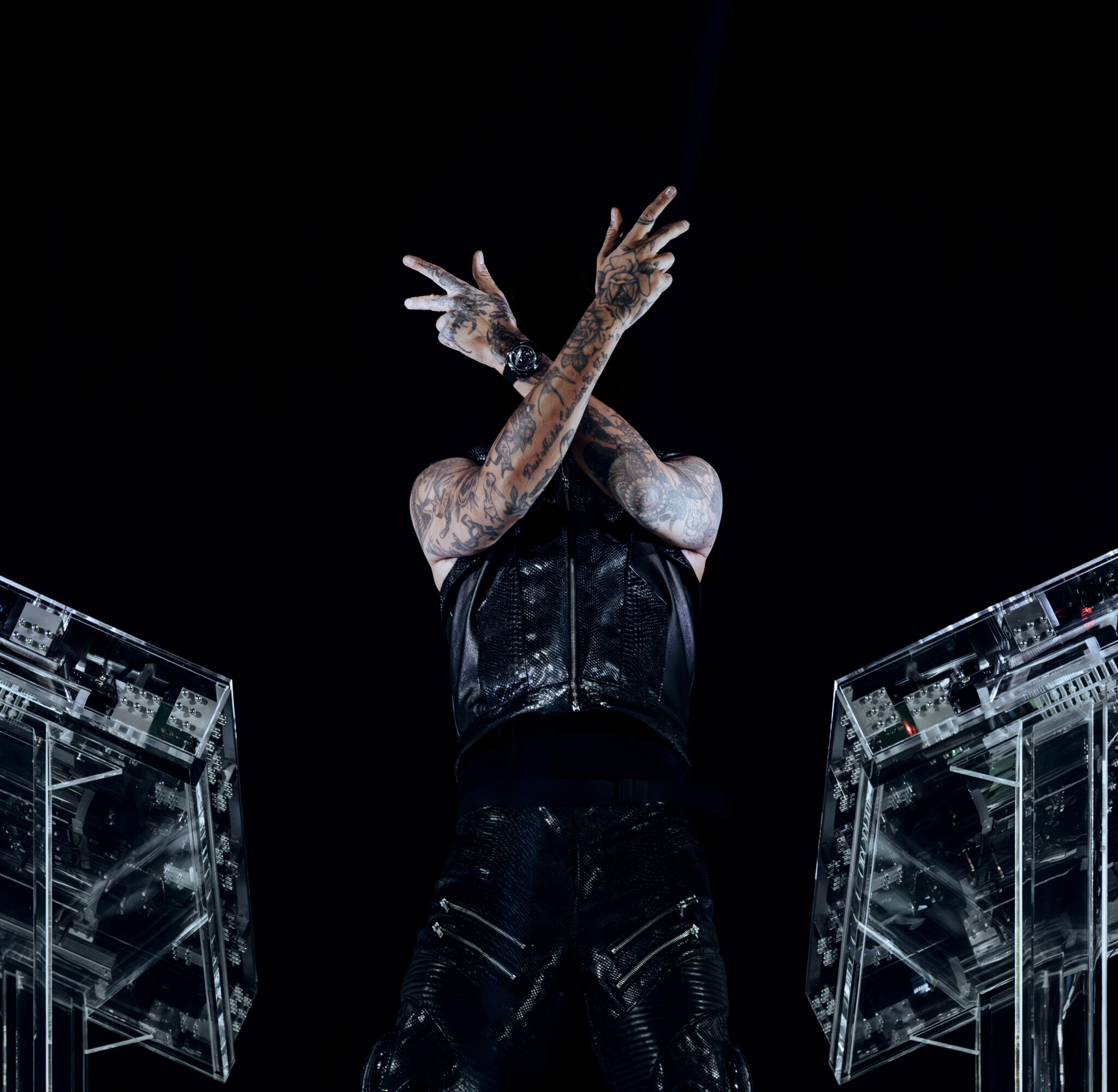 Anyma tattoos: Stage photograph showing the tattoos across Anyma's hands, wrists, and forearms