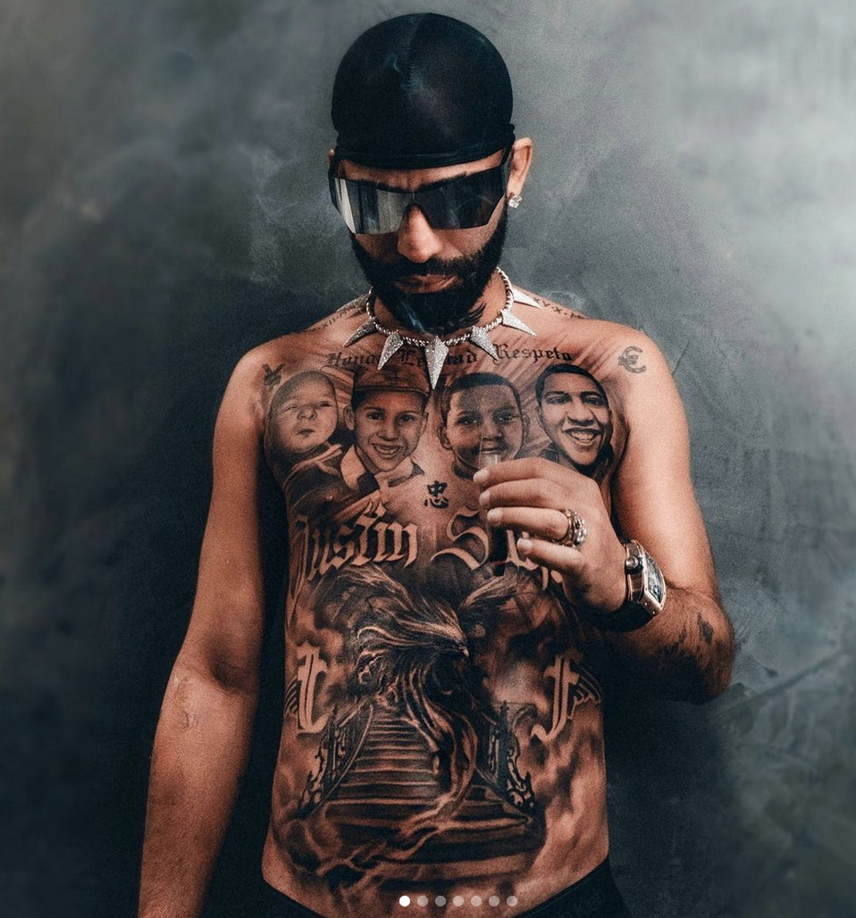 Arcángel tattoos: Tattoo evidence: seated view of the four memorial portraits and lower chest work.