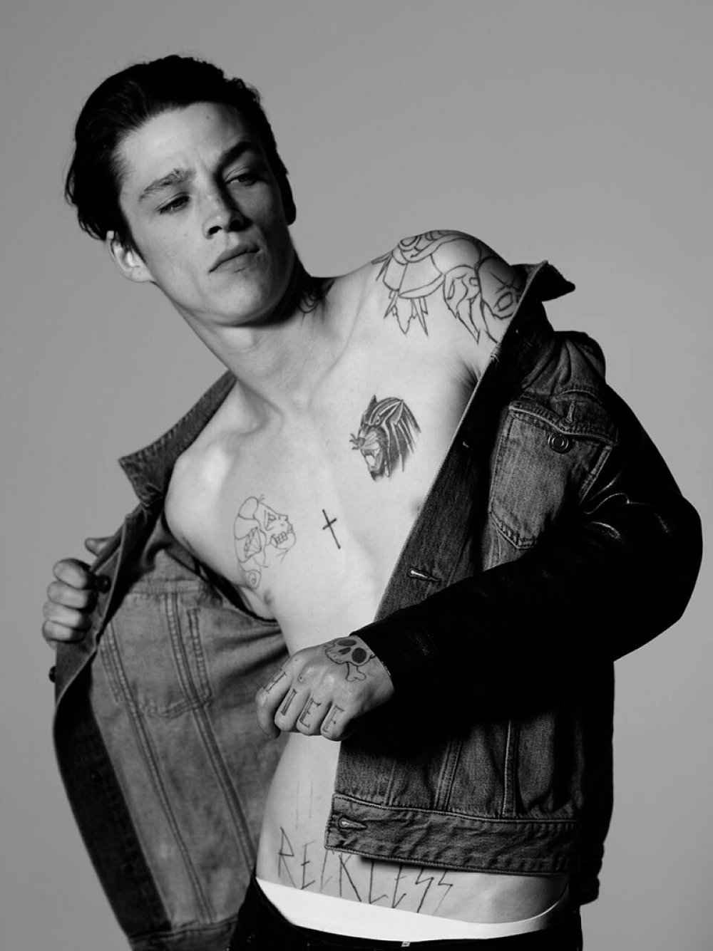 Ash Stymest chest skull cross and reckless lettering tattoos