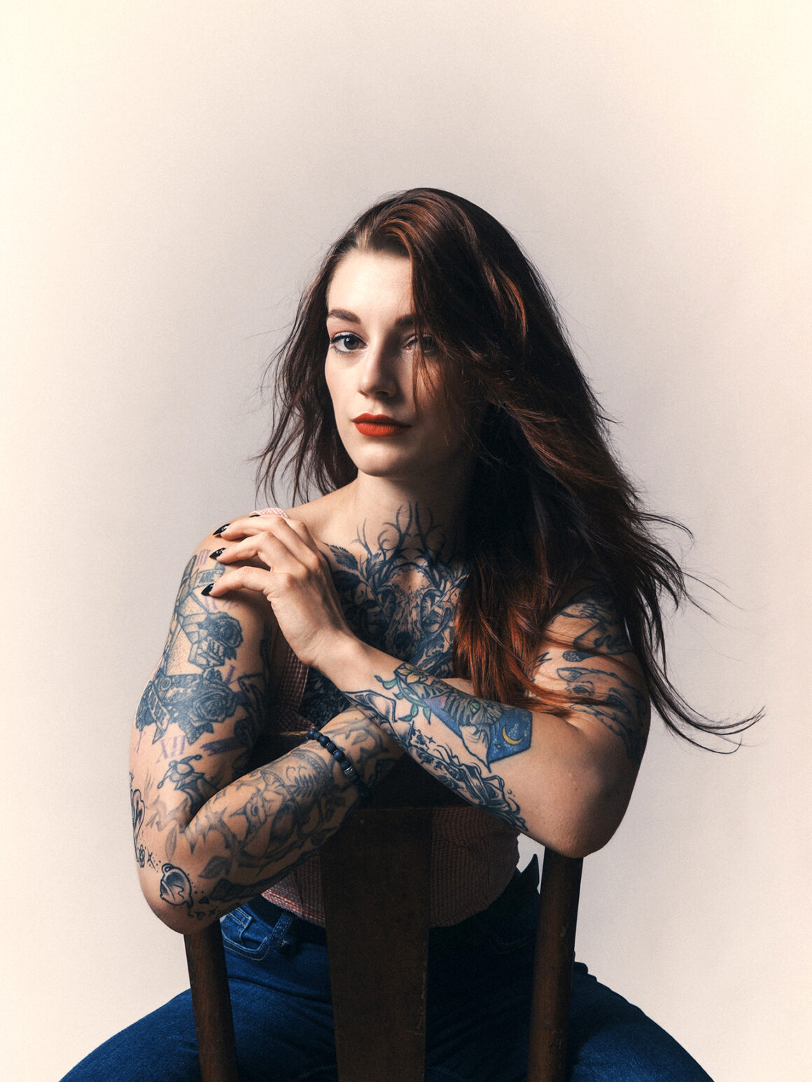 Axelle Fescia tattoos: Provide a close color view of the layered forearm and upper-arm tattoo details.