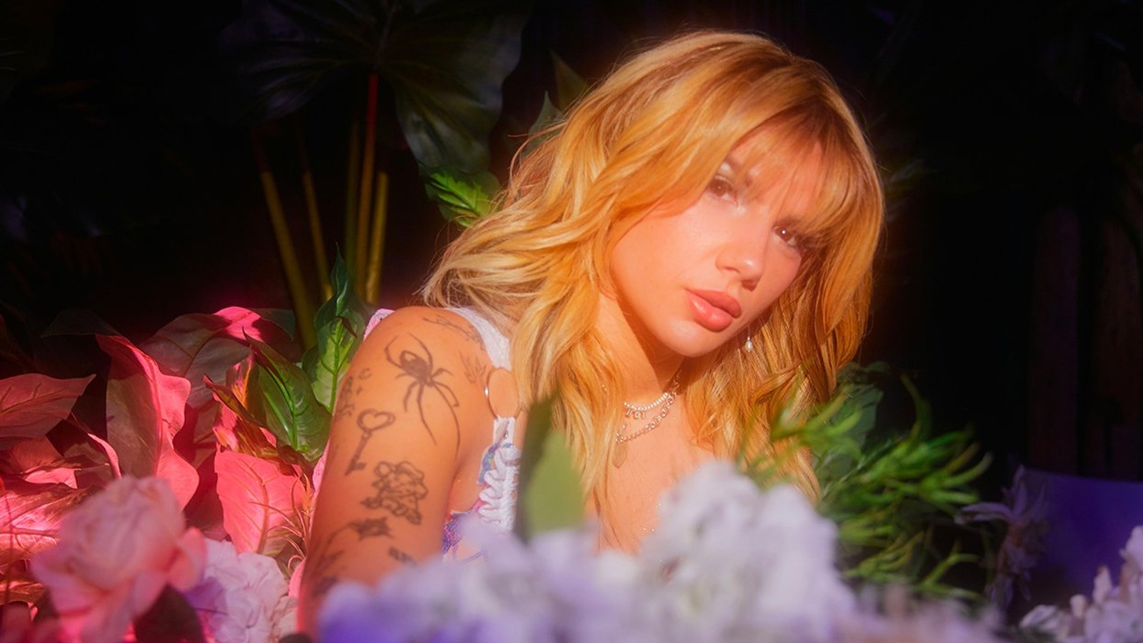 Bailey Spinn tattoos: Genuine Advocate editorial portrait showing several arm tattoos, including the visible spider and key motifs.